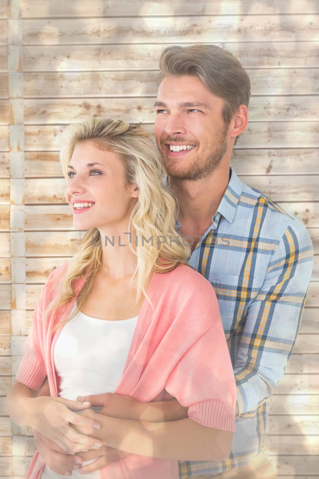 Attractive young couple embracing and smiling against light glowing dots design pattern