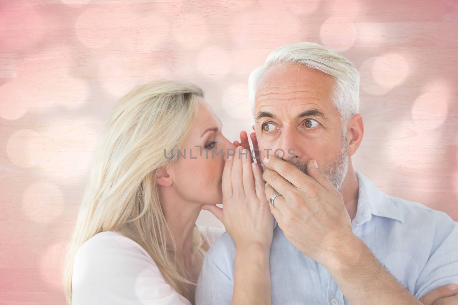 Woman whispering a secret to husband against light circles on grey background