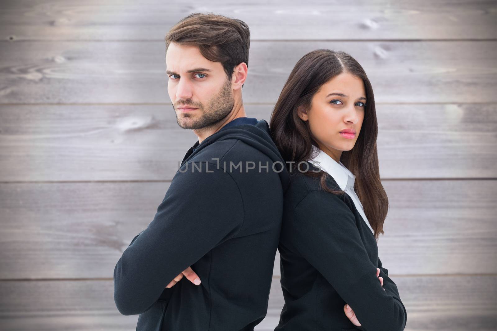 Unhappy couple not speaking to each other  against wooden planks background