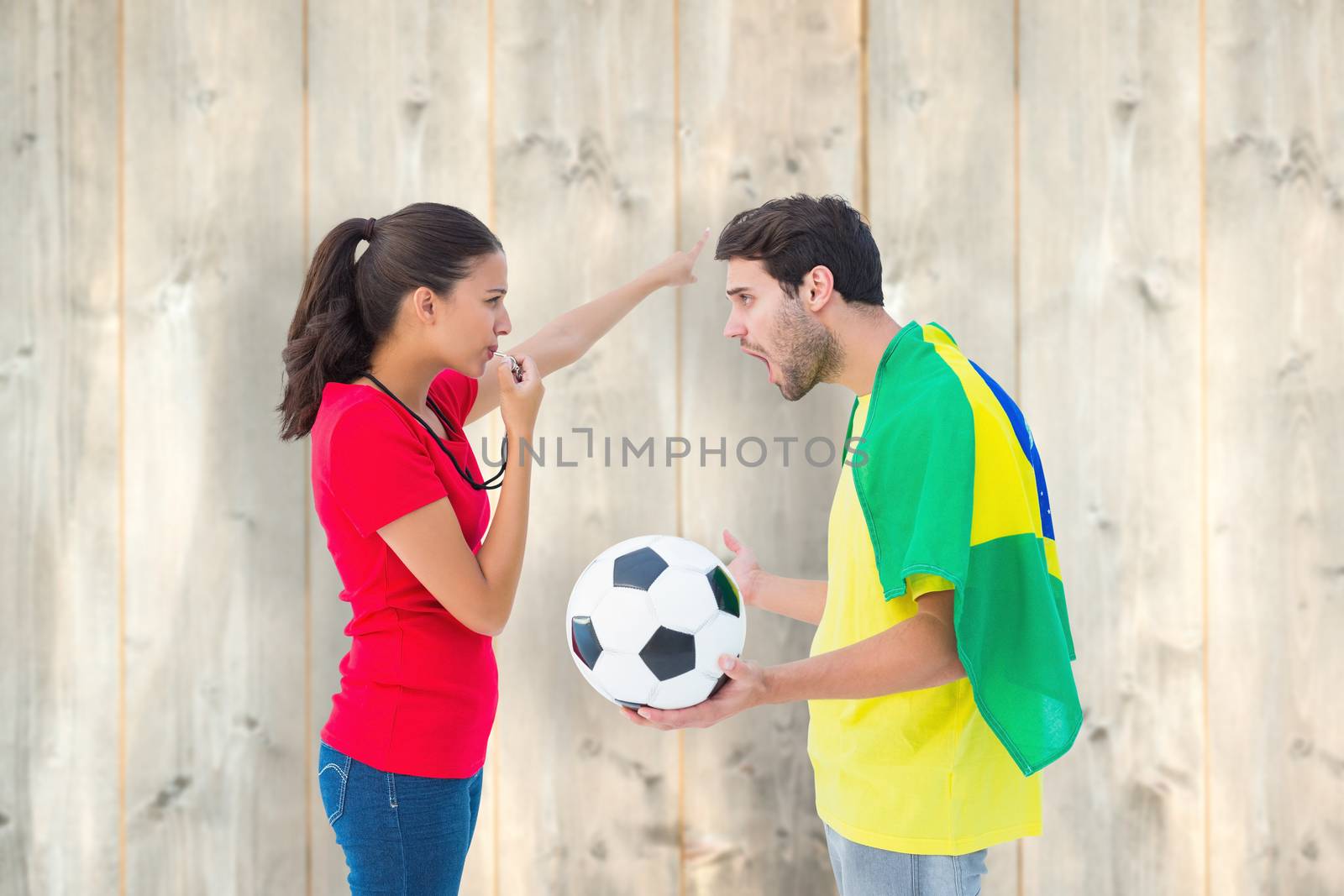 Brunette sending off a brazilian fan  against pale wooden planks
