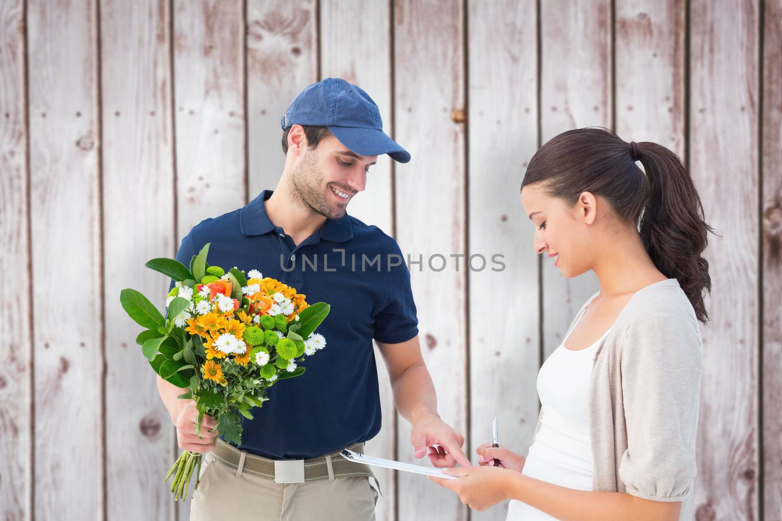 Composite image of happy flower delivery man with customer by Wavebreakmedia