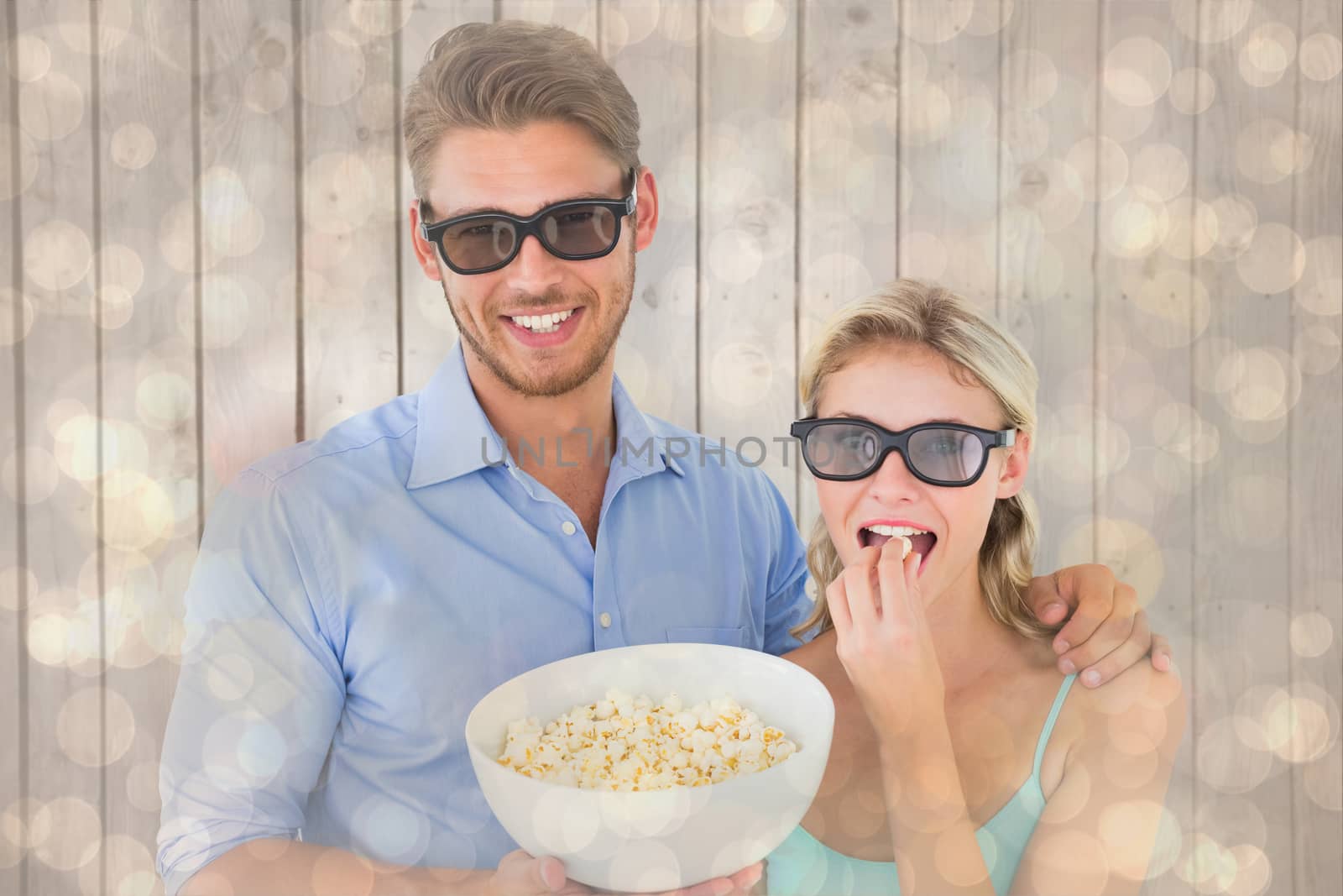 Happy young couple wearing 3d glasses eating popcorn against light glowing dots design pattern