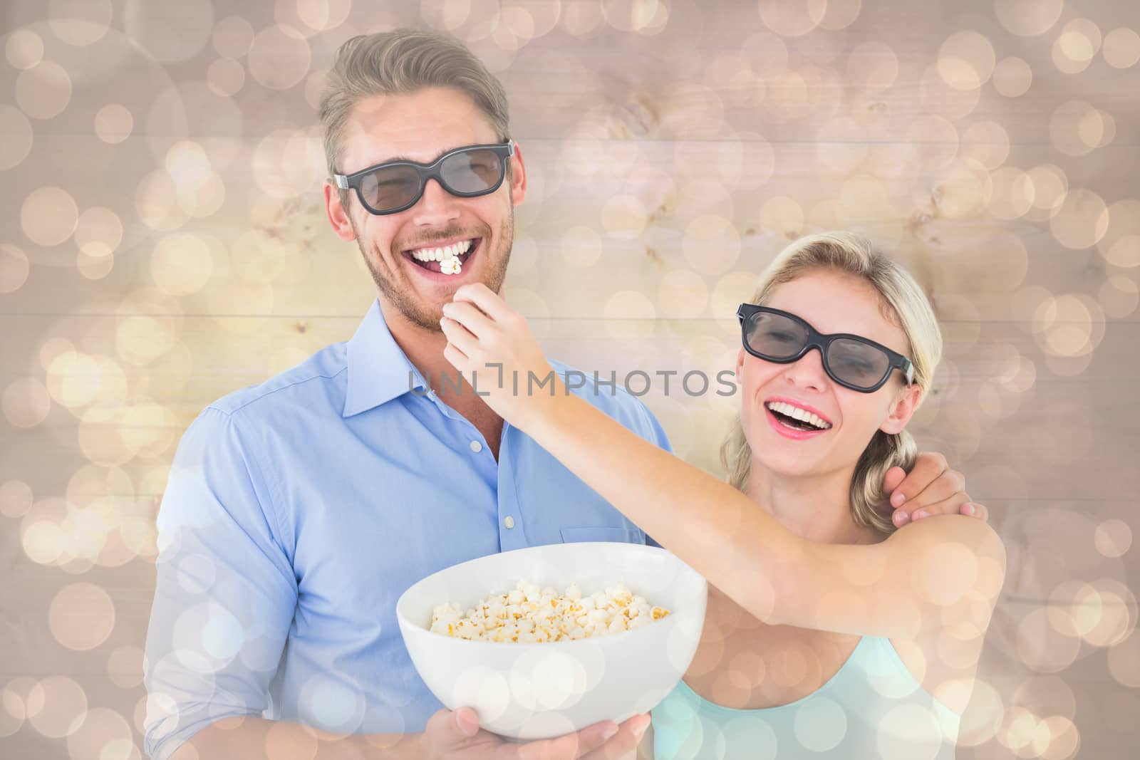 Happy young couple wearing 3d glasses eating popcorn against light glowing dots design pattern