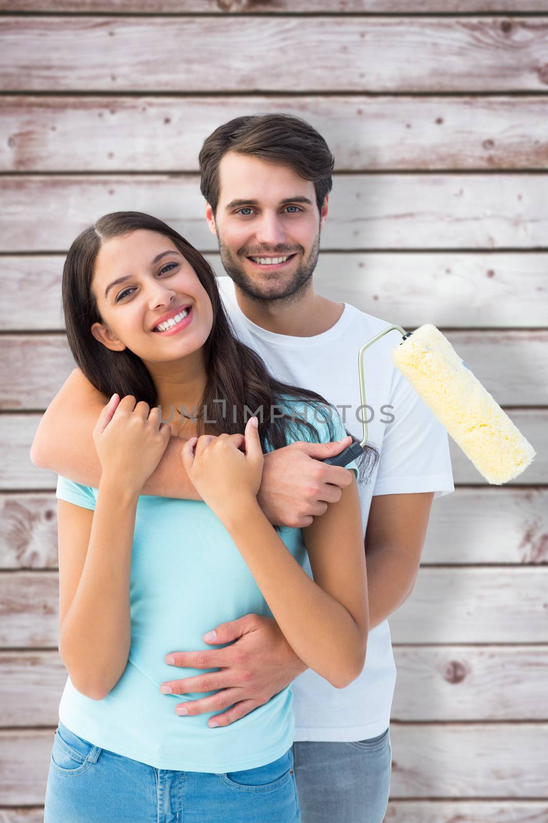 Composite image of happy young couple painting together by Wavebreakmedia