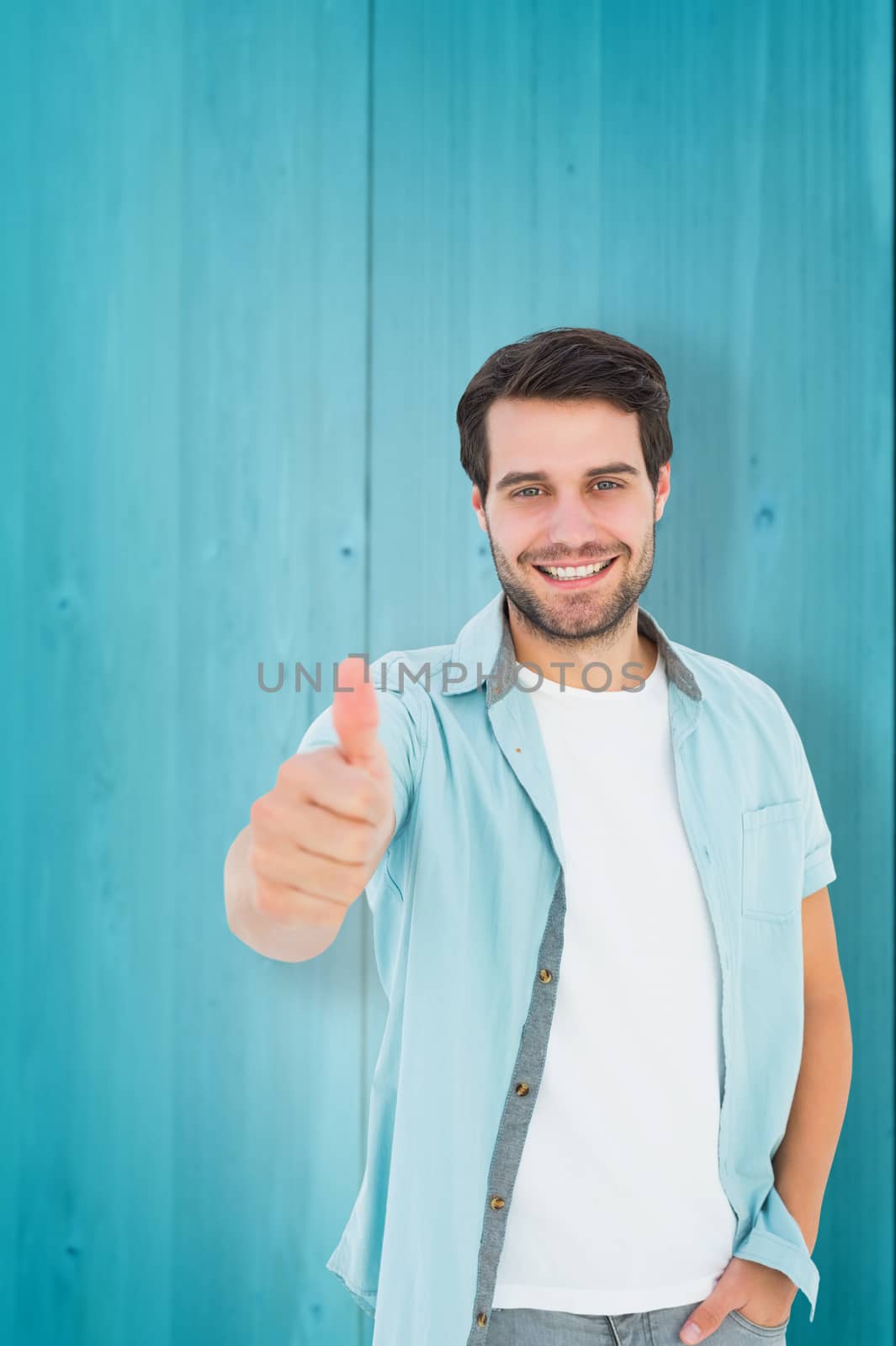 Composite image of happy casual man showing thumbs up by Wavebreakmedia