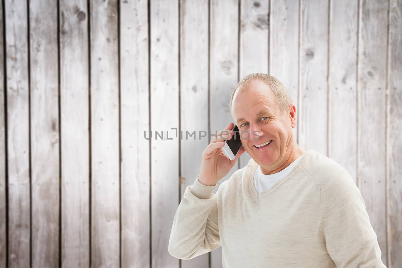 Composite image of happy mature man on the phone by Wavebreakmedia