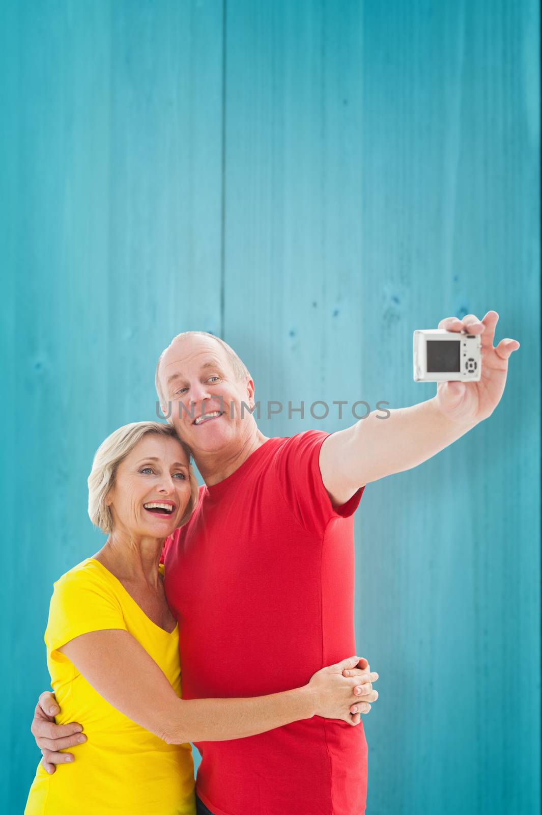 Composite image of happy mature couple taking a selfie together by Wavebreakmedia