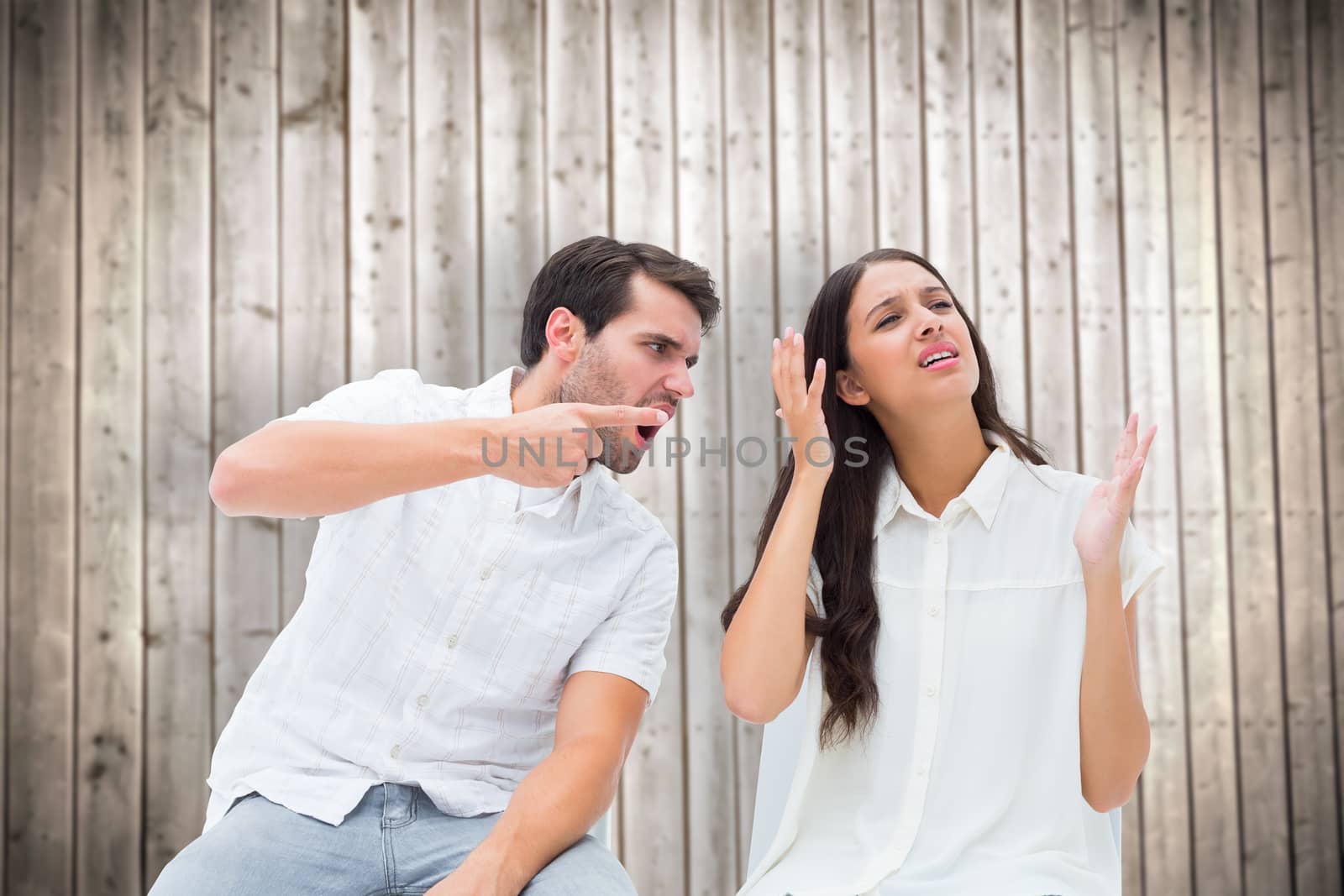 Composite image of couple sitting on chairs arguing by Wavebreakmedia