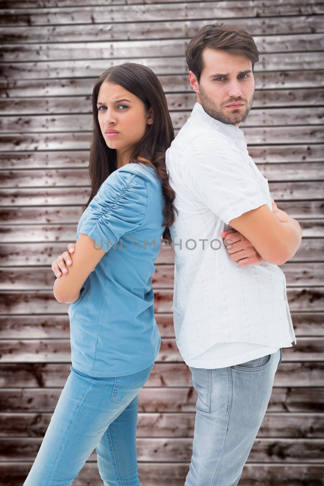 Upset couple not talking to each other after fight against wooden planks