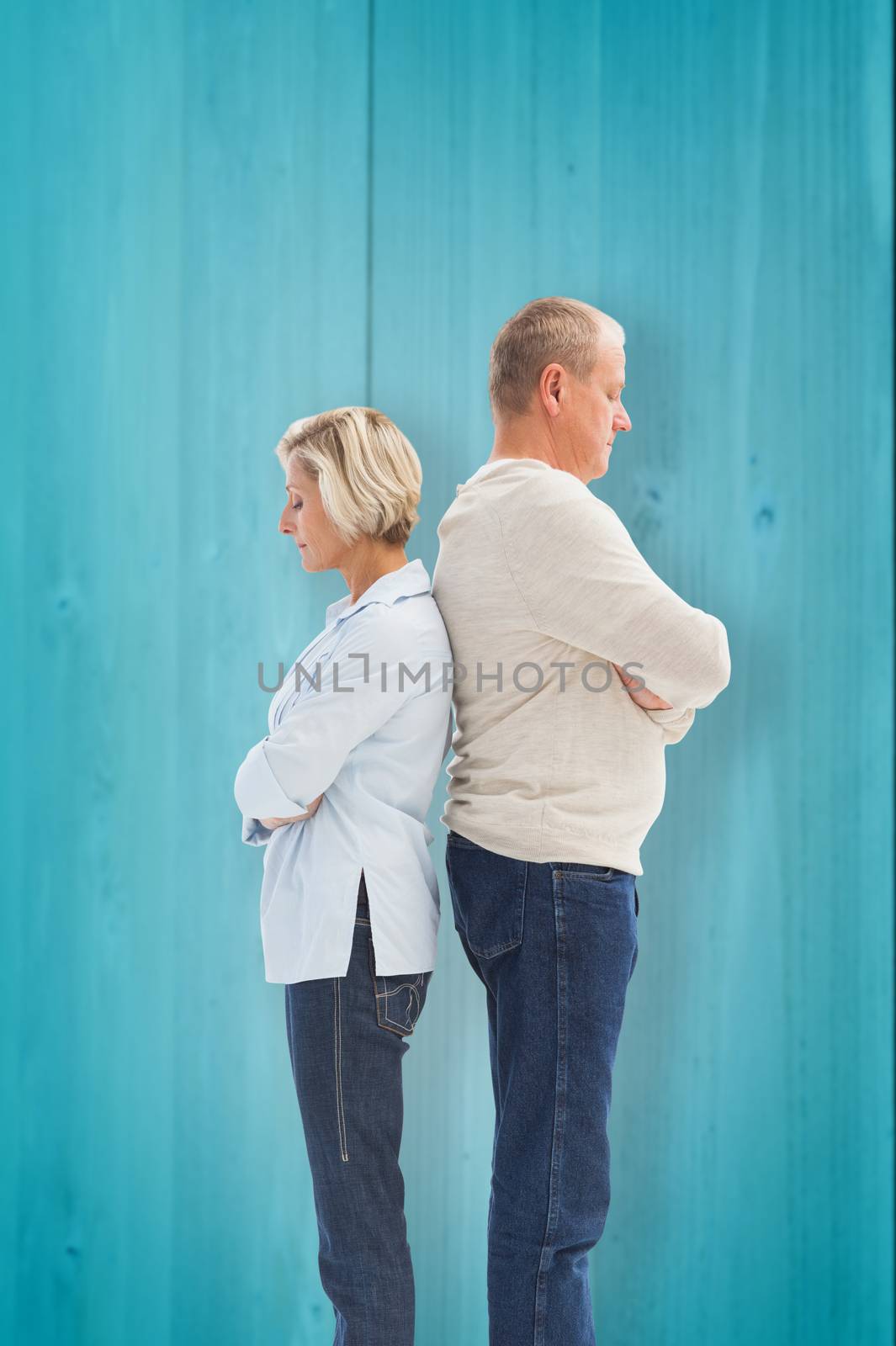 Unhappy couple not speaking to each other  against wooden planks background