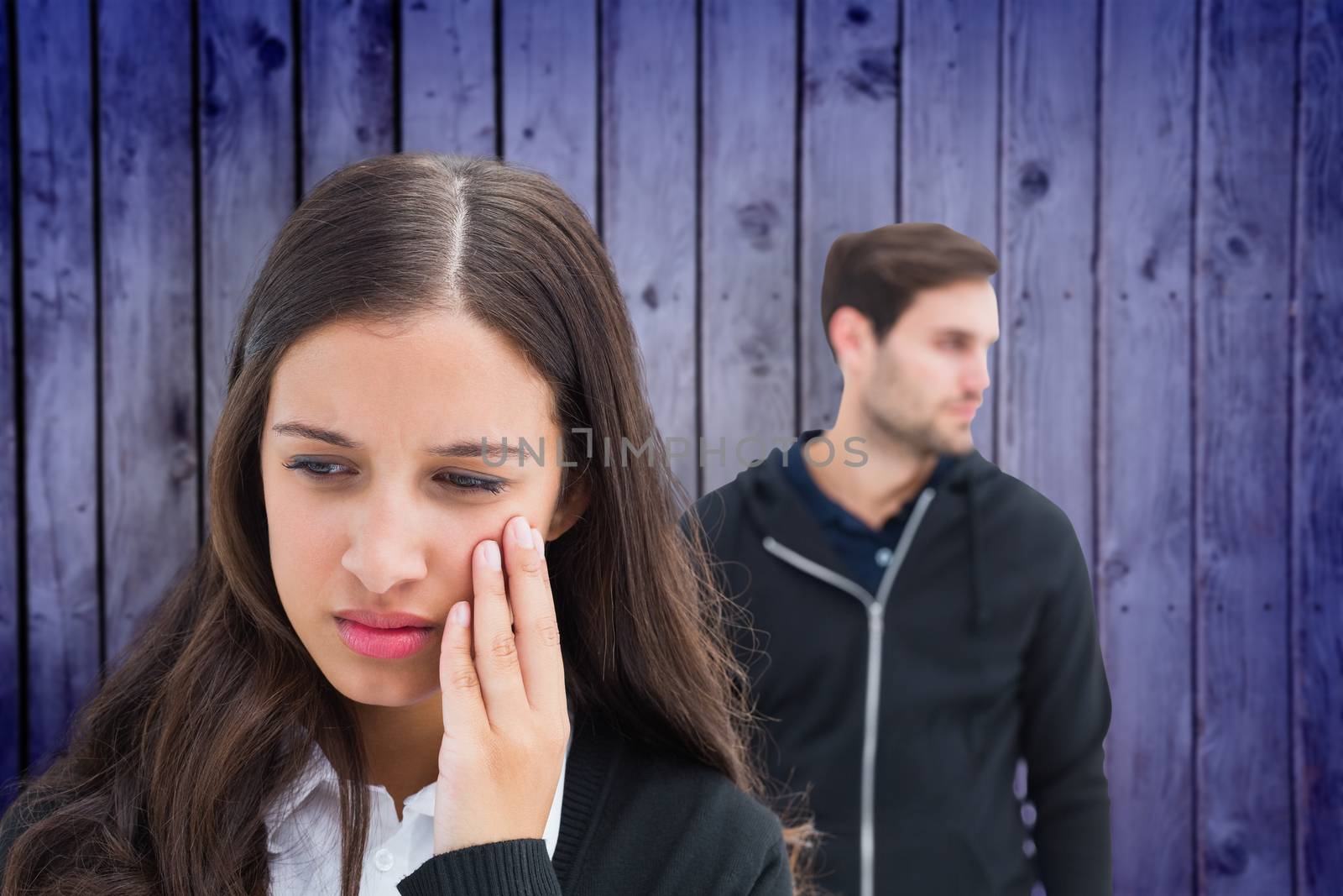 Unhappy couple not speaking to each other  against wooden planks background
