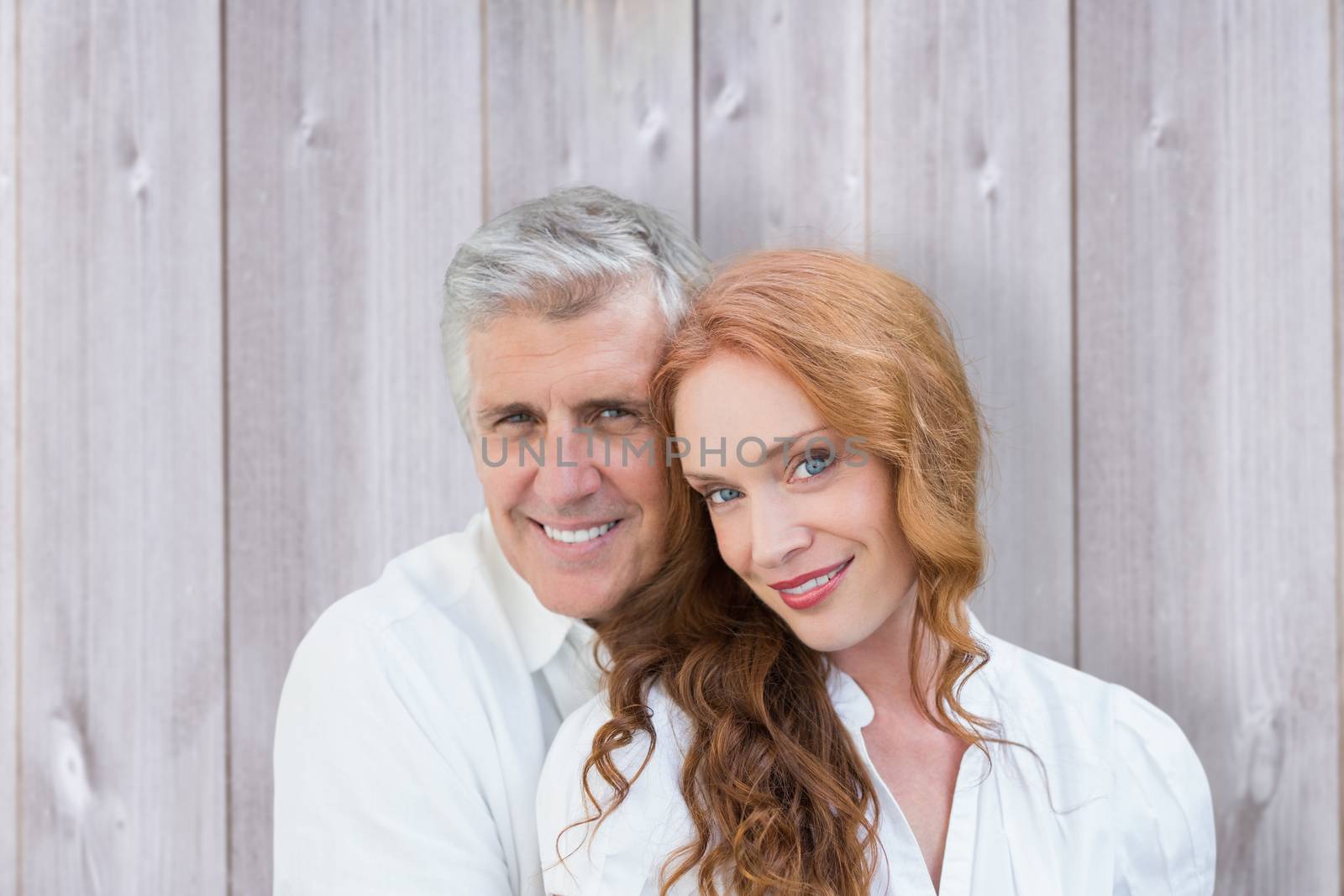 Loving couple against wooden background