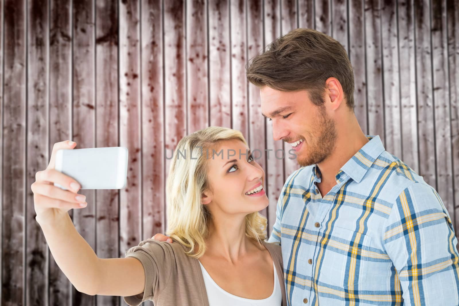Composite image of attractive couple taking a selfie together by Wavebreakmedia