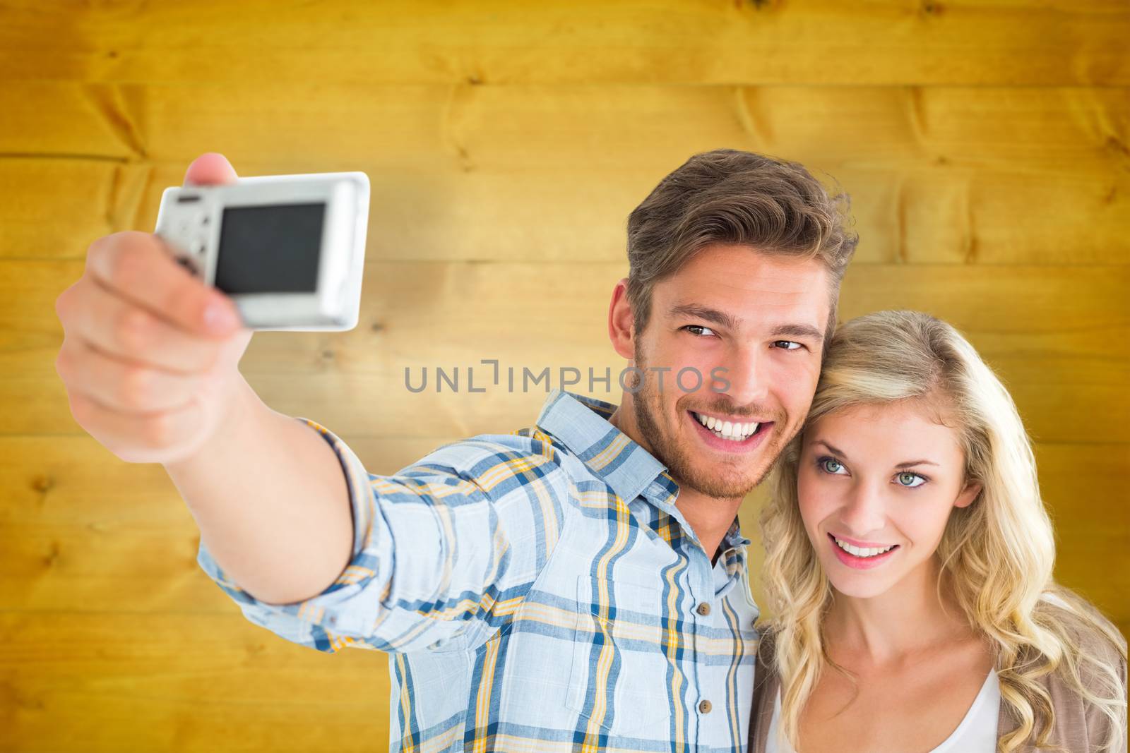 Composite image of attractive couple taking a selfie together by Wavebreakmedia