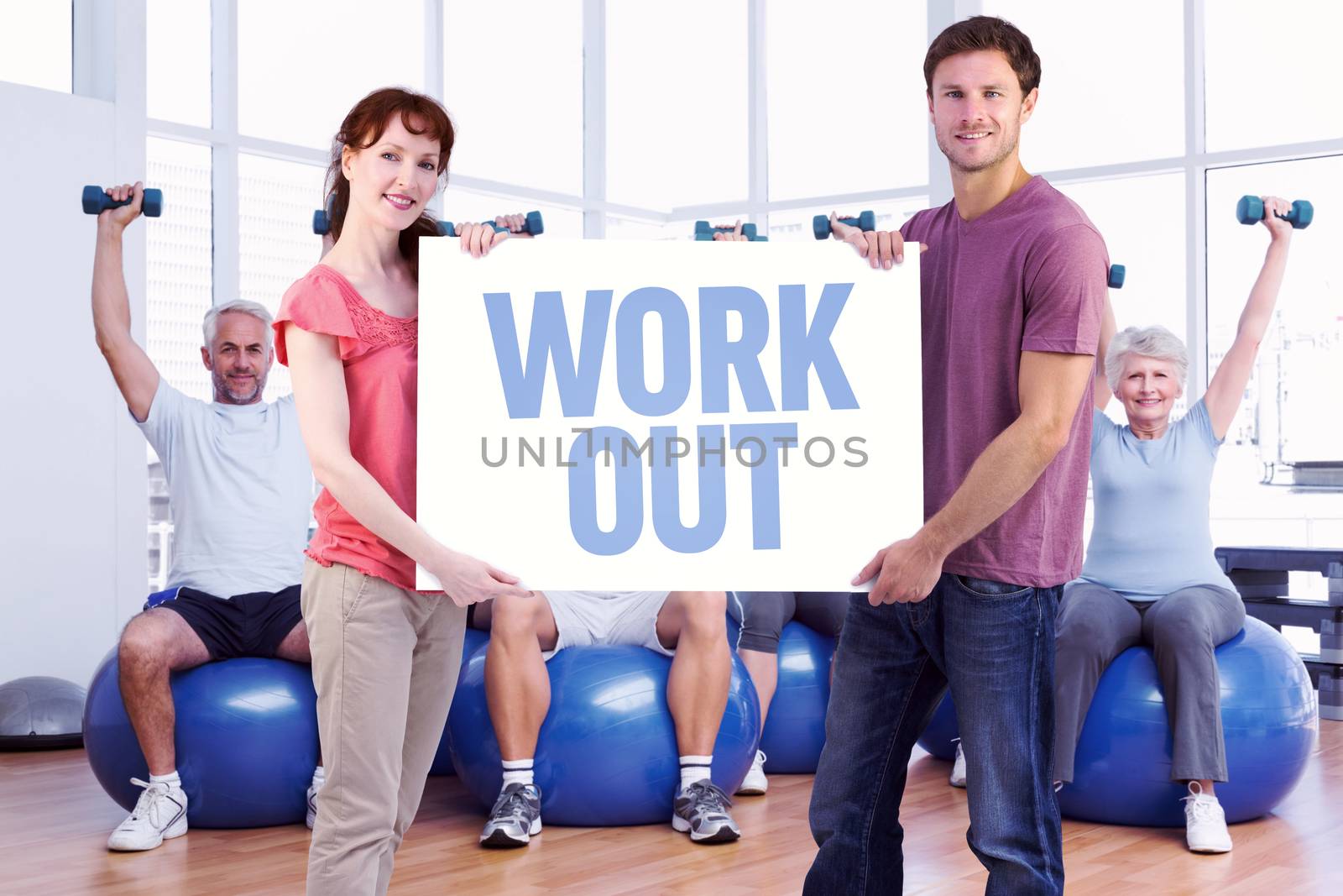 Couple holding a white sign against work out