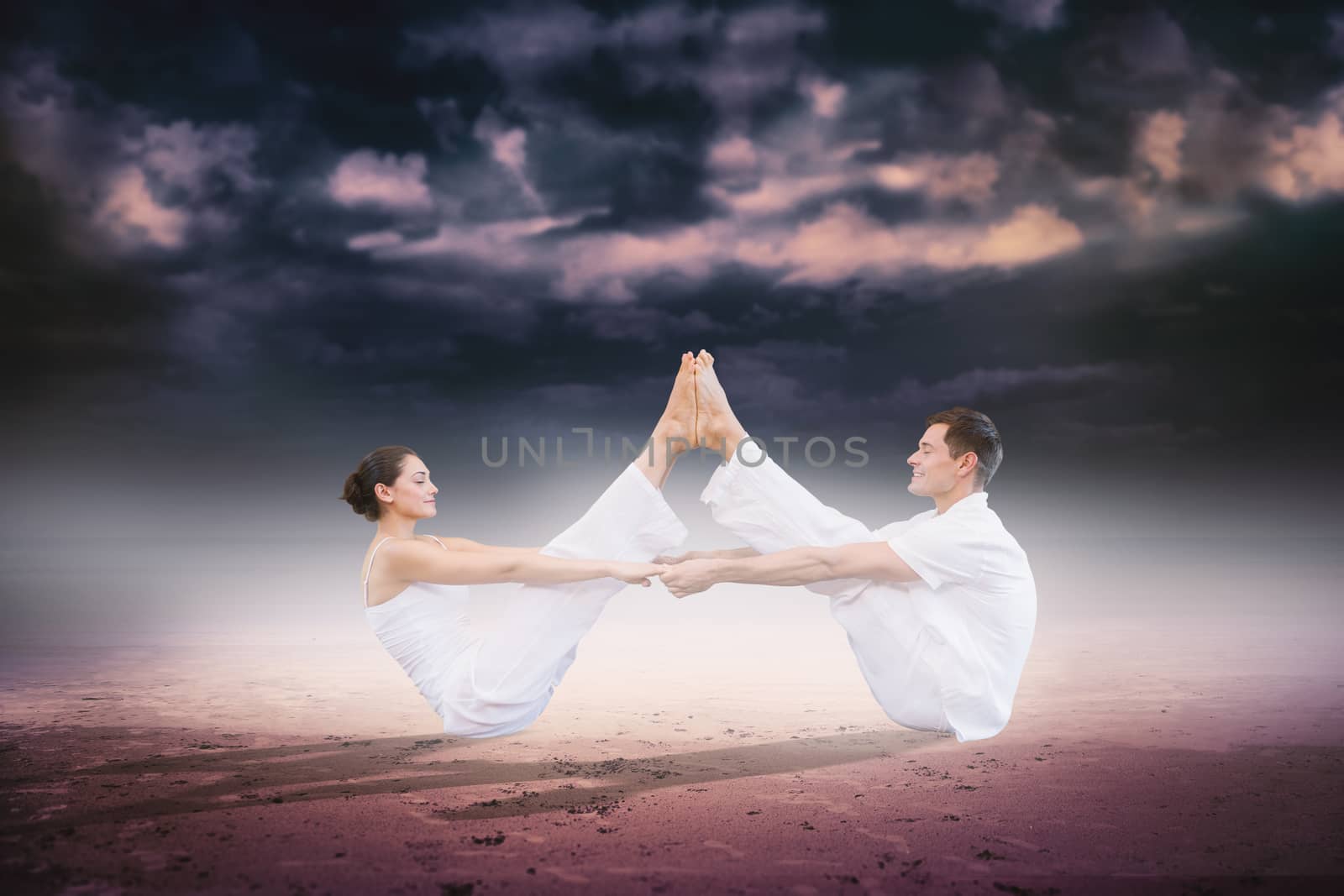 Peaceful couple sitting in boat position together against dark cloudy sky