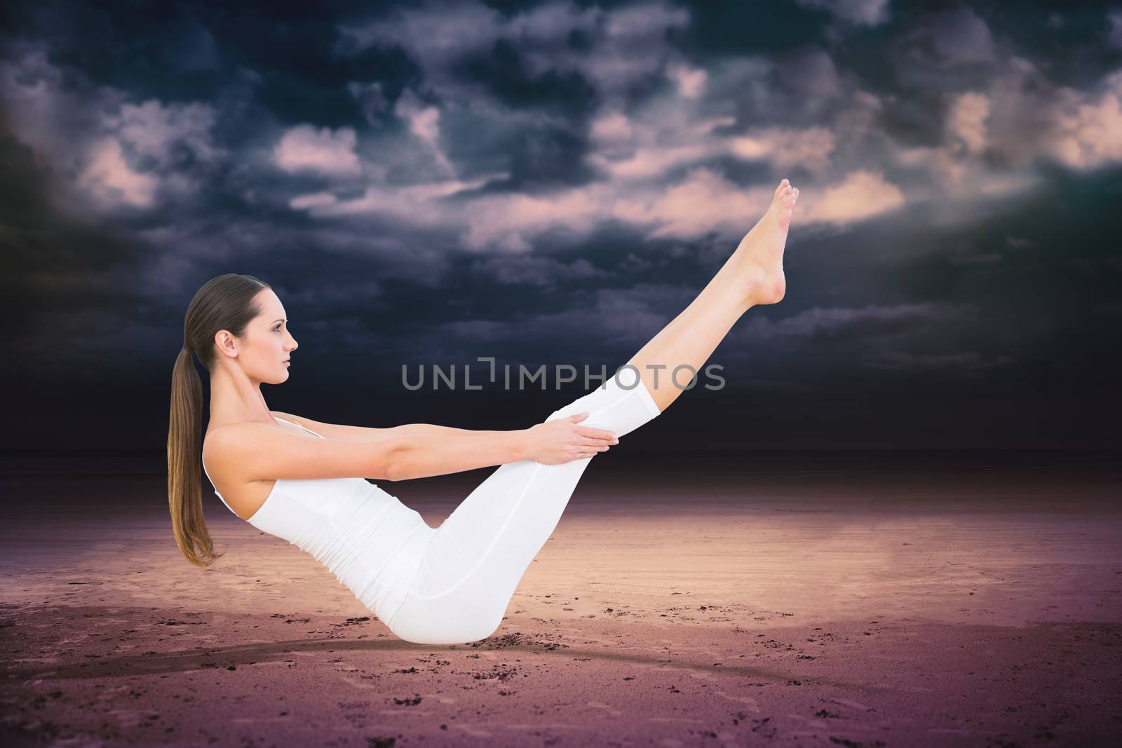 Toned woman doing the boat pose in fitness studio against dark cloudy sky