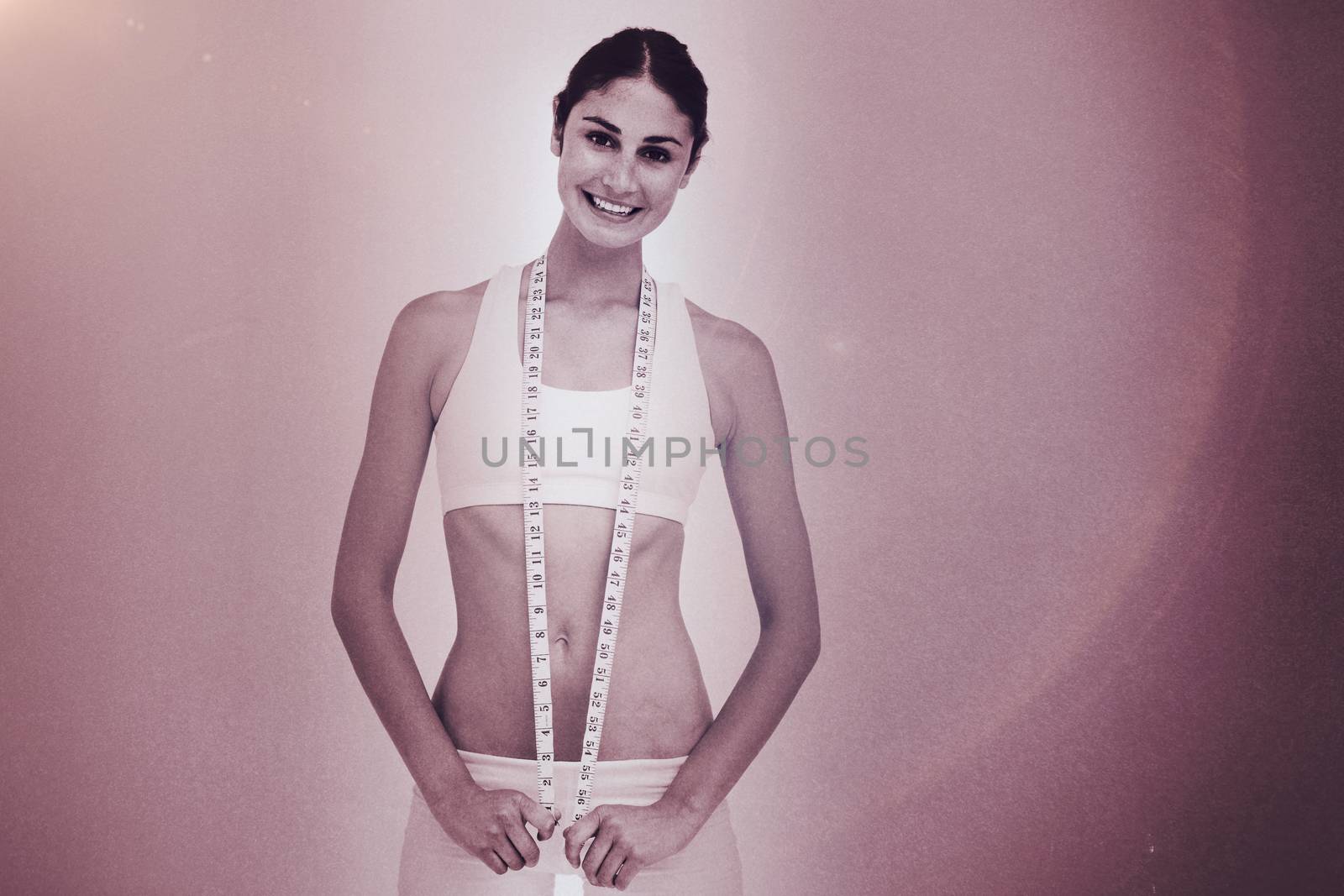 Composite image of slim woman with a measure tape by Wavebreakmedia