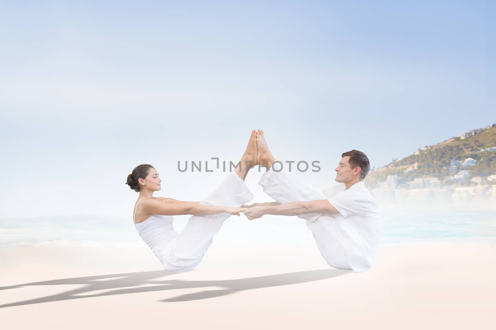 Peaceful couple sitting in boat position together against beautiful beach and blue sky