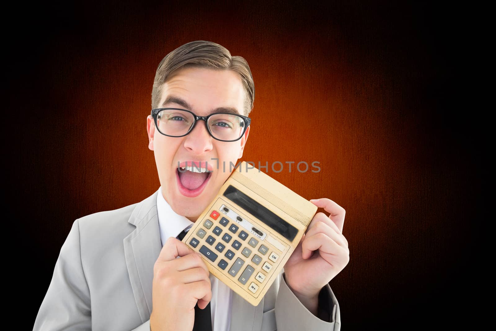 Geeky smiling businessman showing calculator against white and grey background