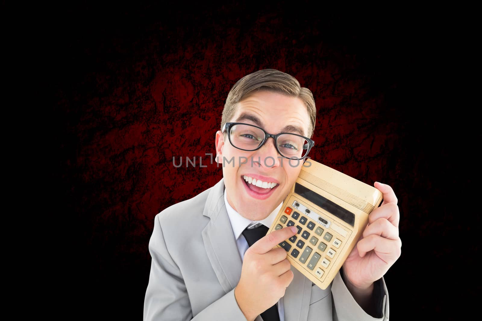 Composite image of geeky smiling businessman showing calculator by Wavebreakmedia