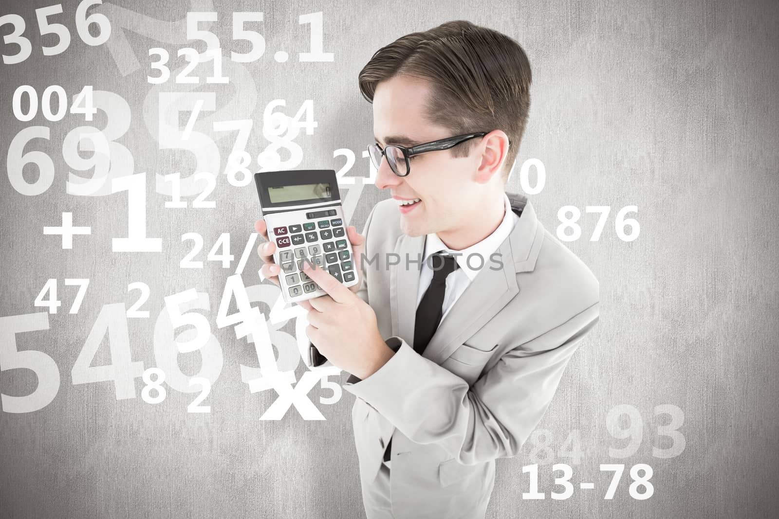 Geeky smiling businessman showing calculator against white background