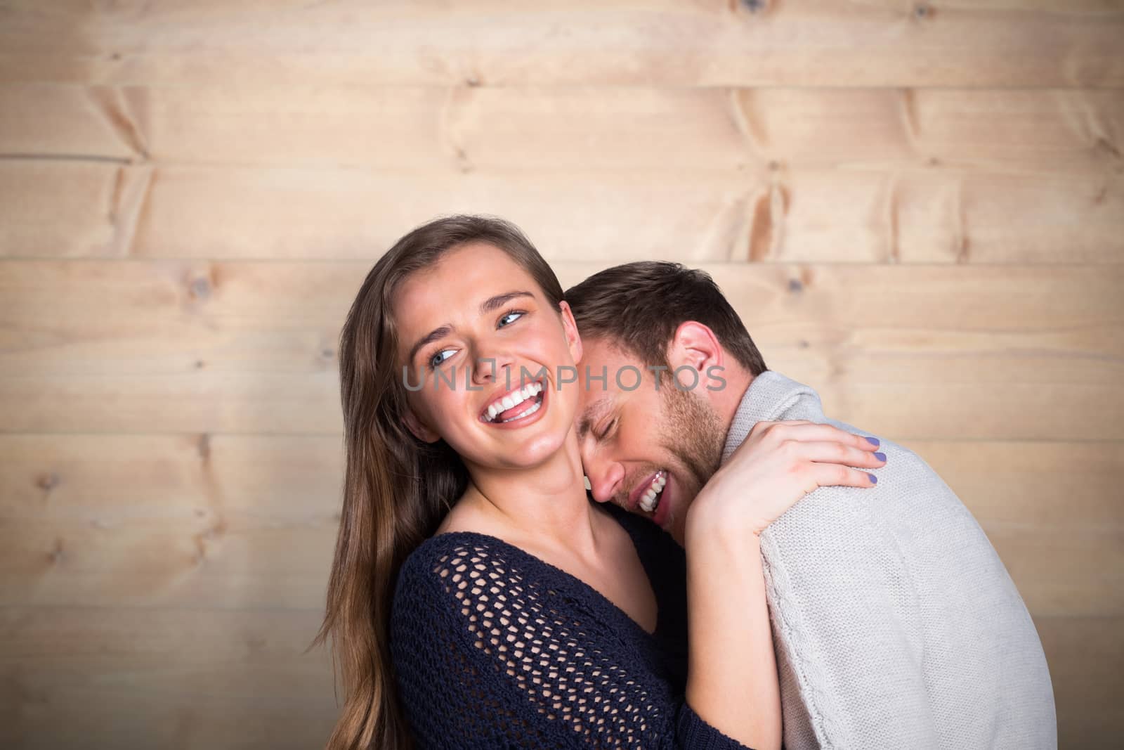 Close up of happy young couple against bleached wooden planks background