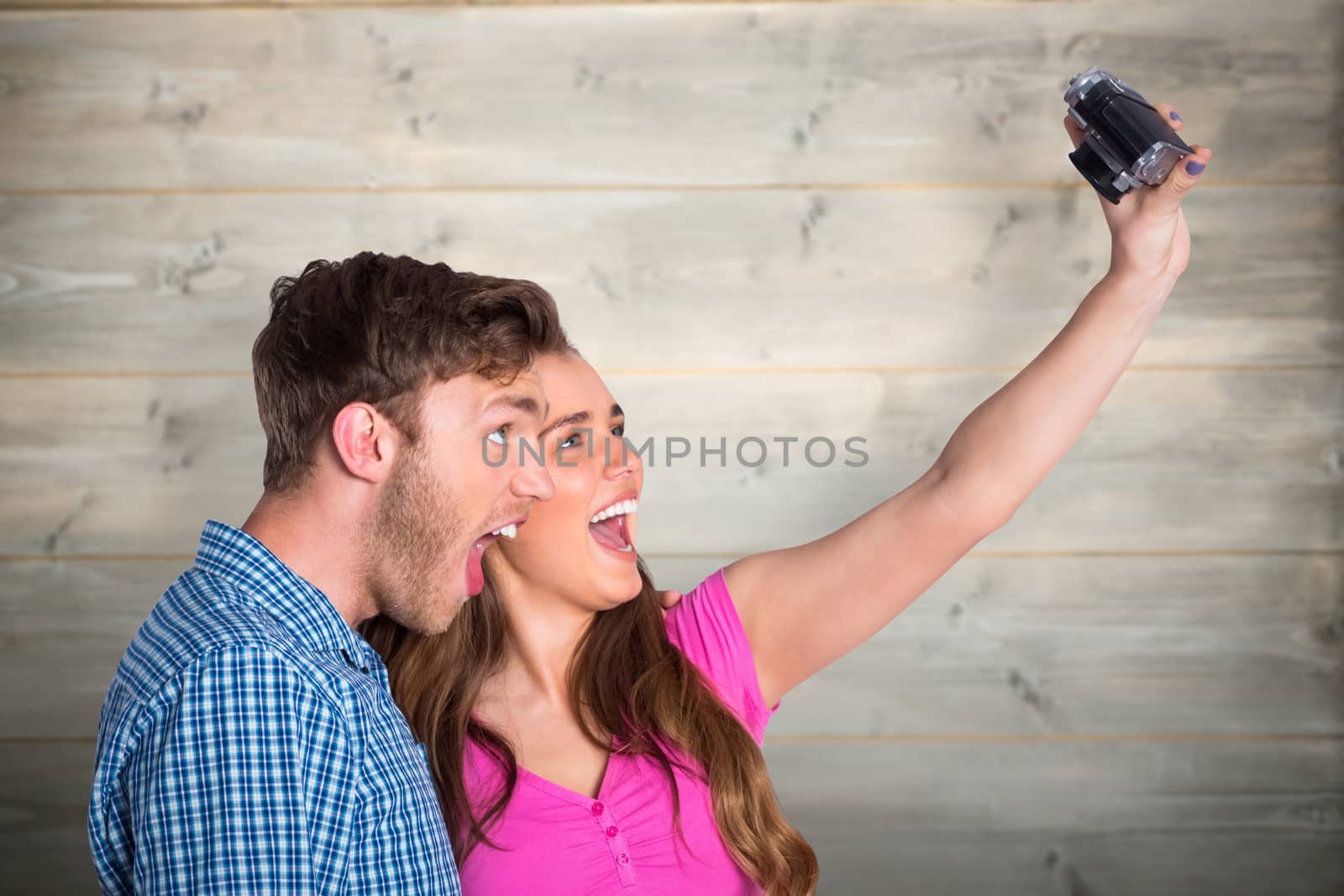Composite image of couple taking selfie with digital camera by Wavebreakmedia