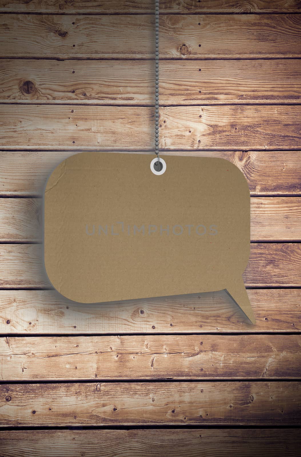 Speech bubble tag hanging against wooden planks background