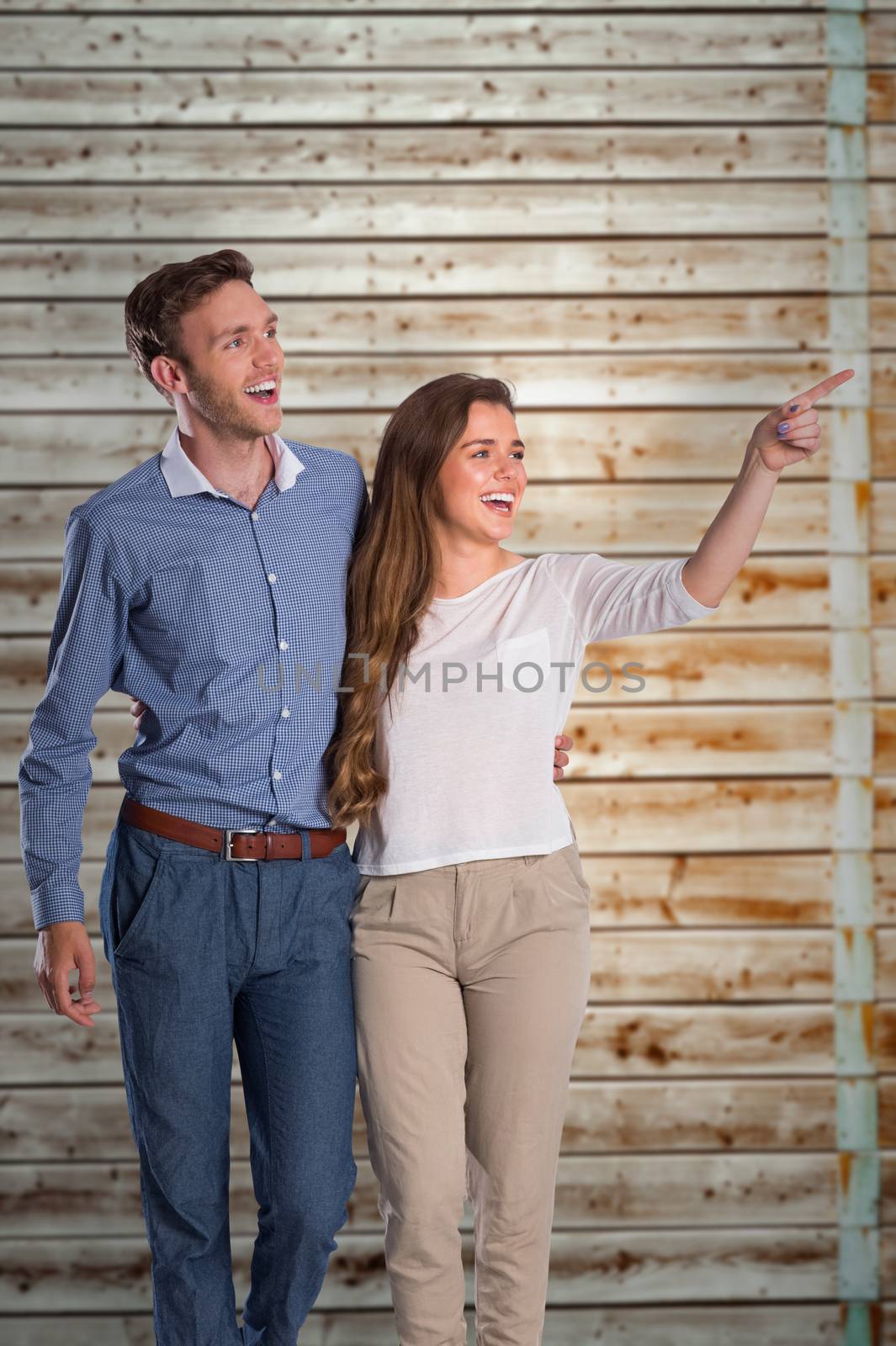 Full length of couple looking away against faded pine wooden planks