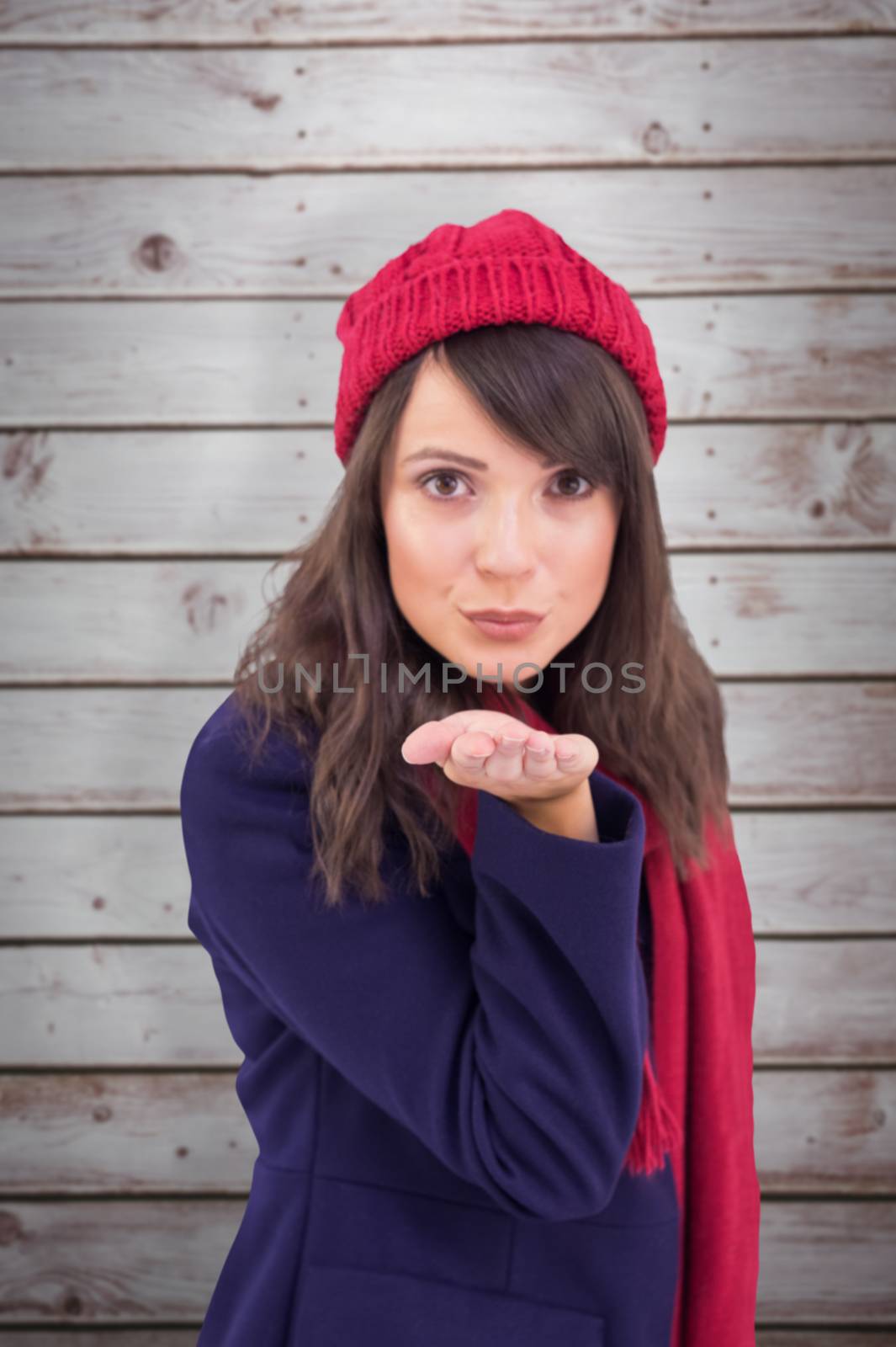Composite image of festive brunette blowing a kiss by Wavebreakmedia