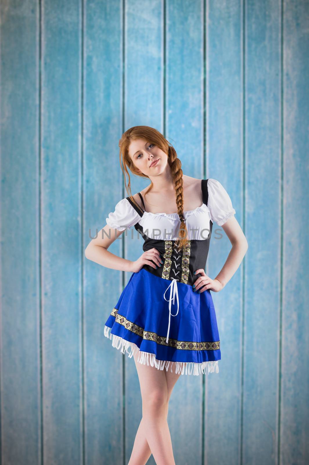 Oktoberfest girl looking at camera against wooden planks