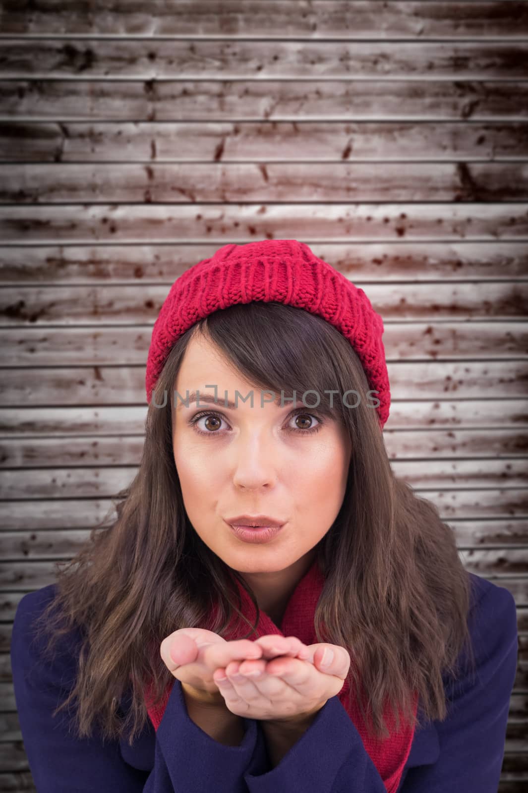 Composite image of festive brunette blowing over hands by Wavebreakmedia