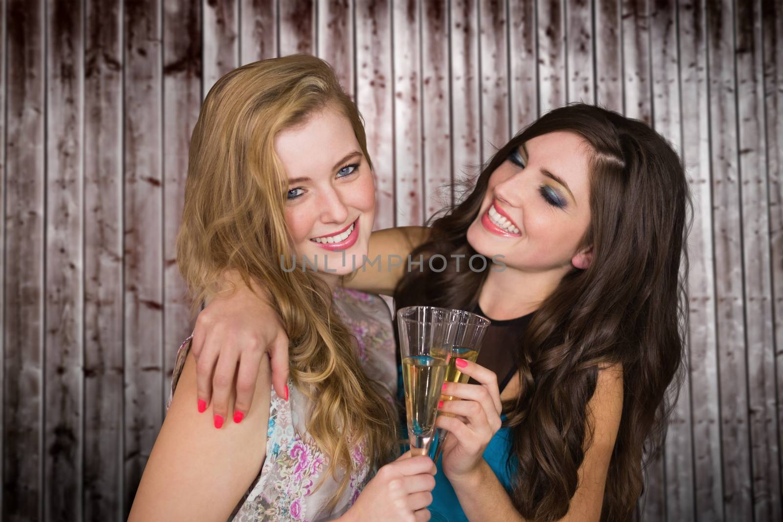 Friends drinking champagne against wooden planks