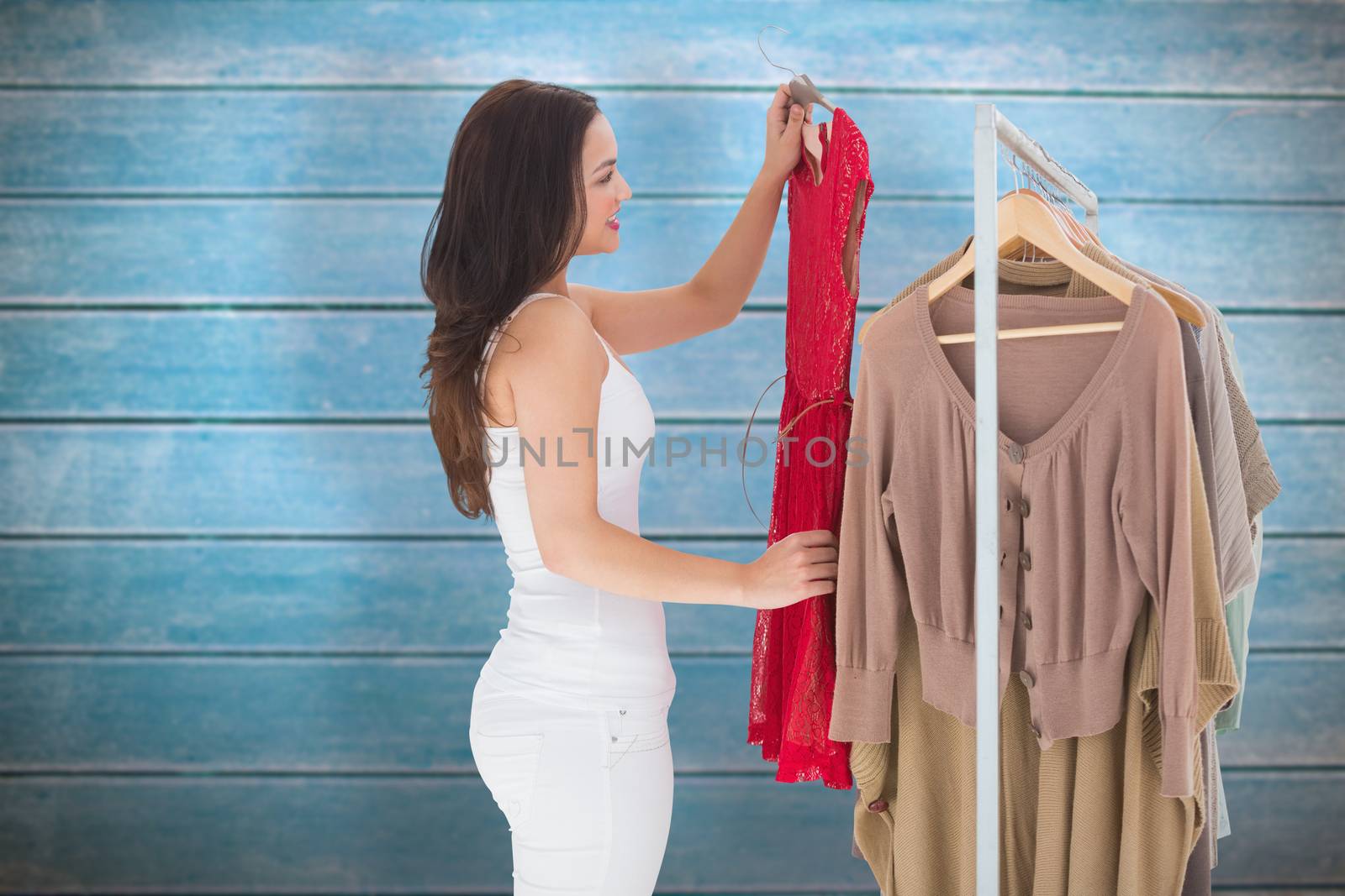 Woman choosing clothes against wooden planks