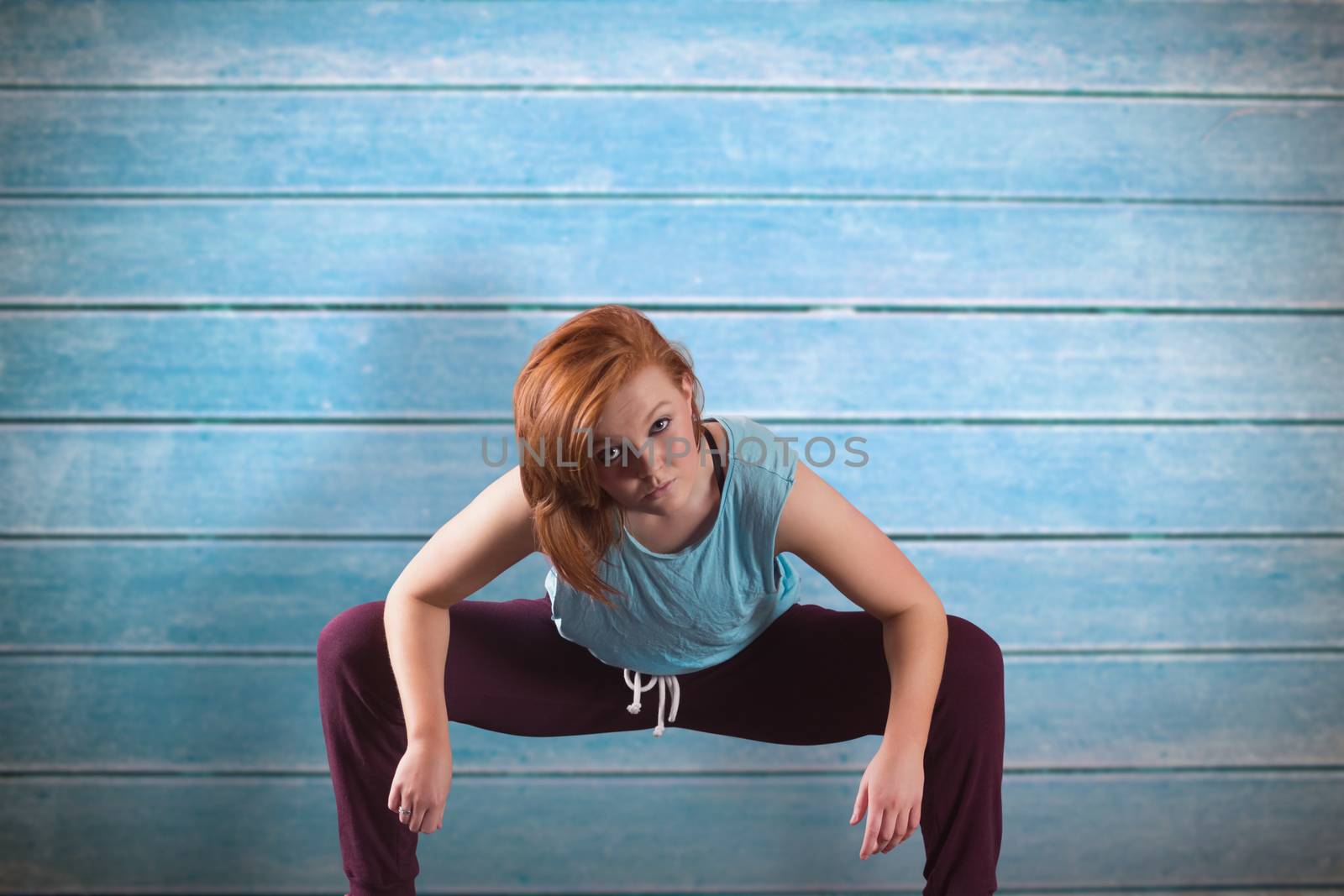 Pretty break dancer against wooden planks