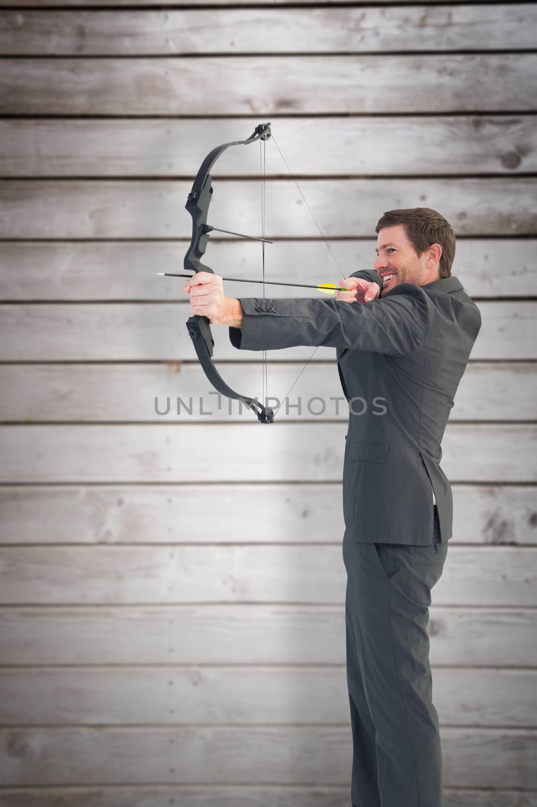 Composite image of businessman shooting a bow and arrow by Wavebreakmedia