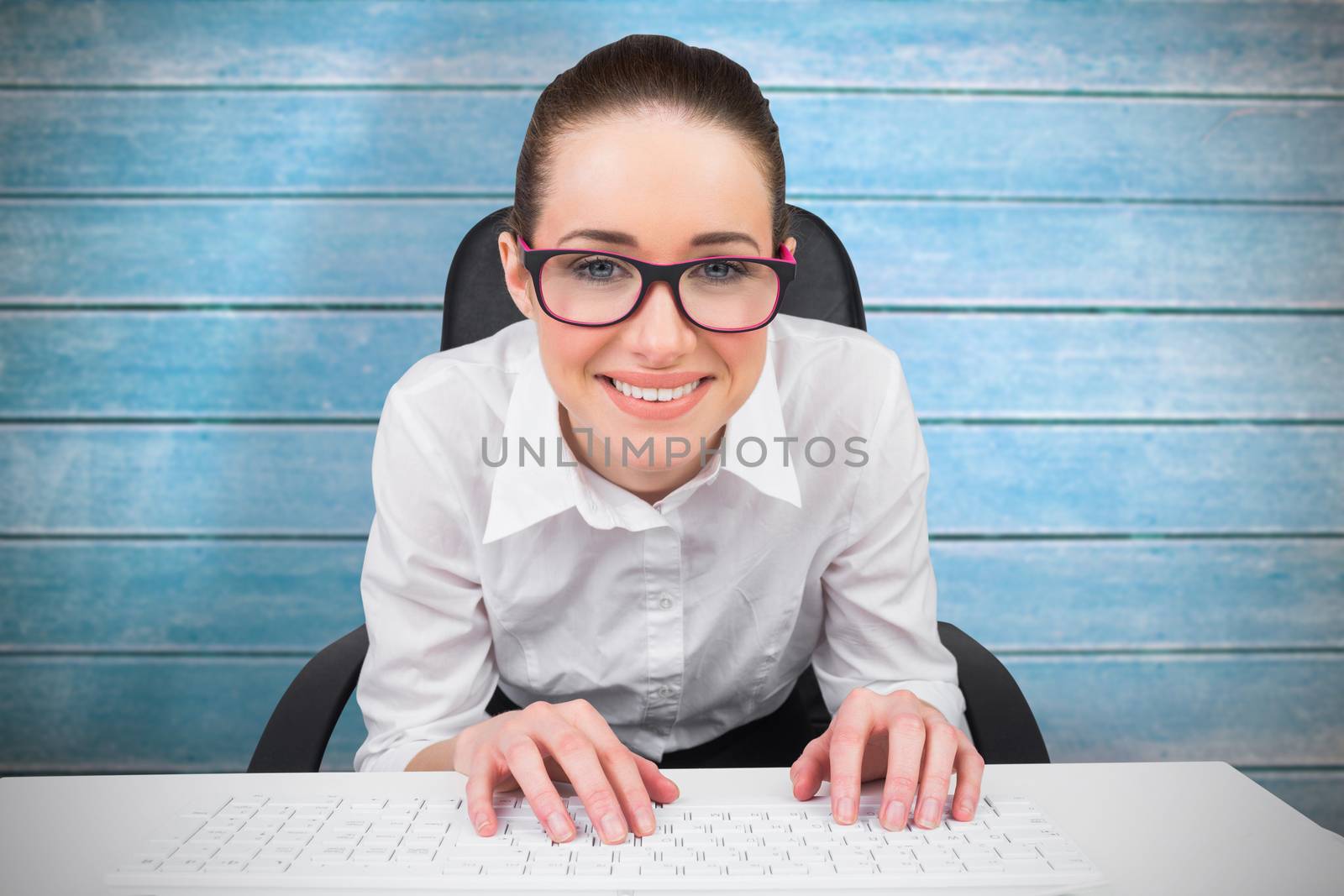Businesswoman typing on a keyboard against wooden planks