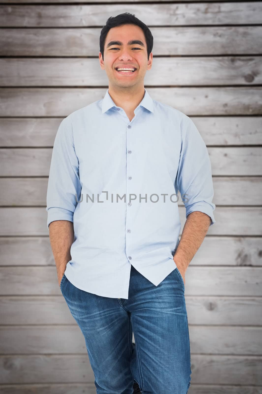 Composite image of smiling casual man standing by Wavebreakmedia