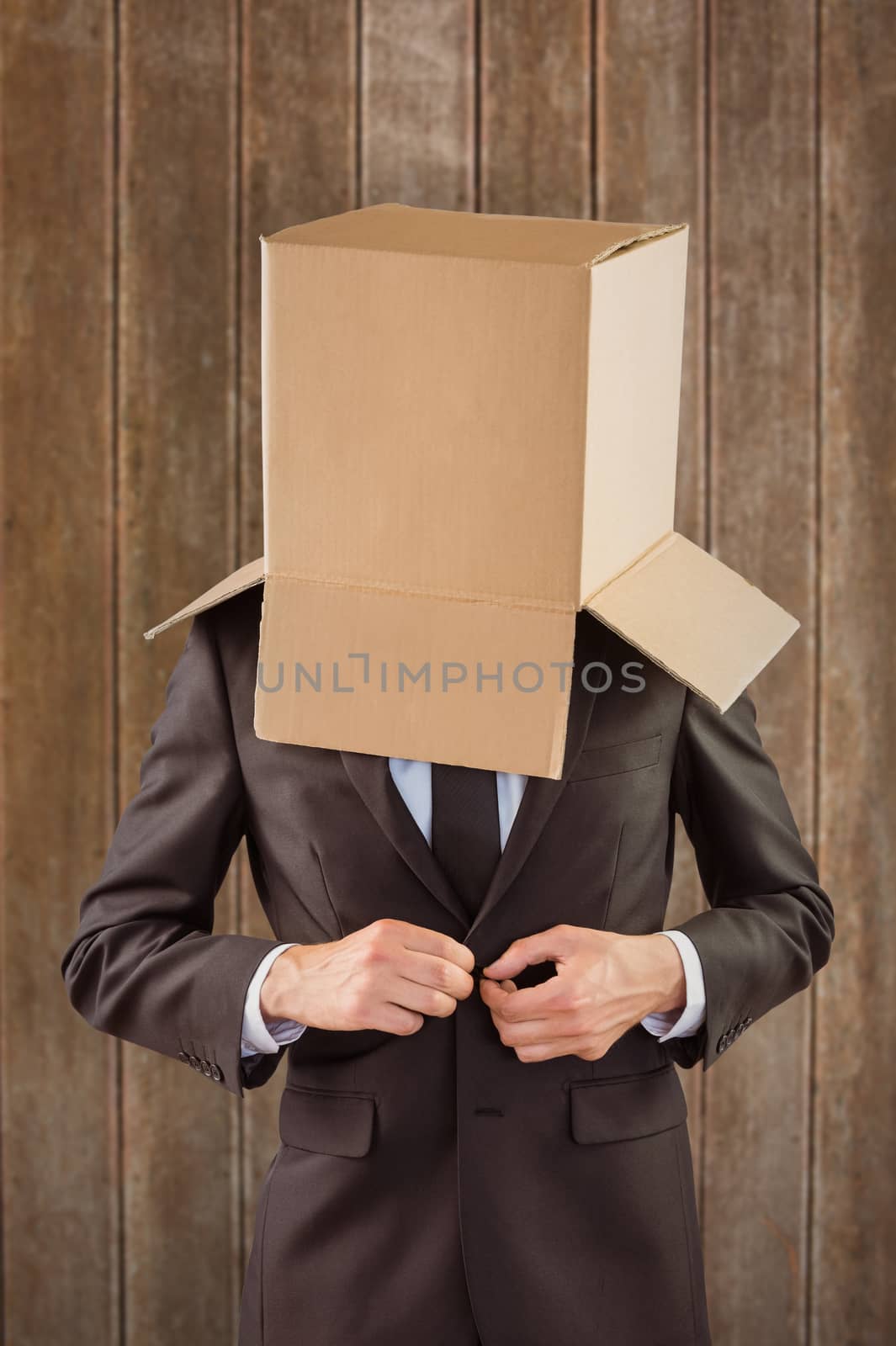 Anonymous businessman buttoning his jacket against wooden planks background