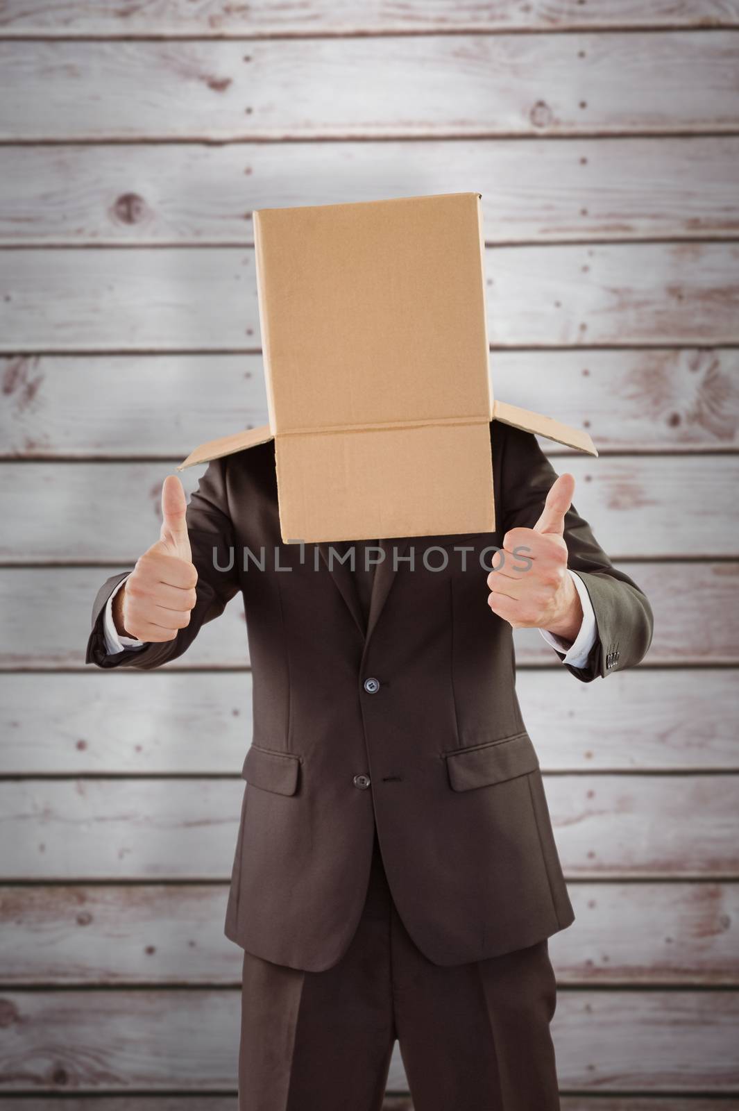 Composite image of anonymous businessman with thumbs up by Wavebreakmedia