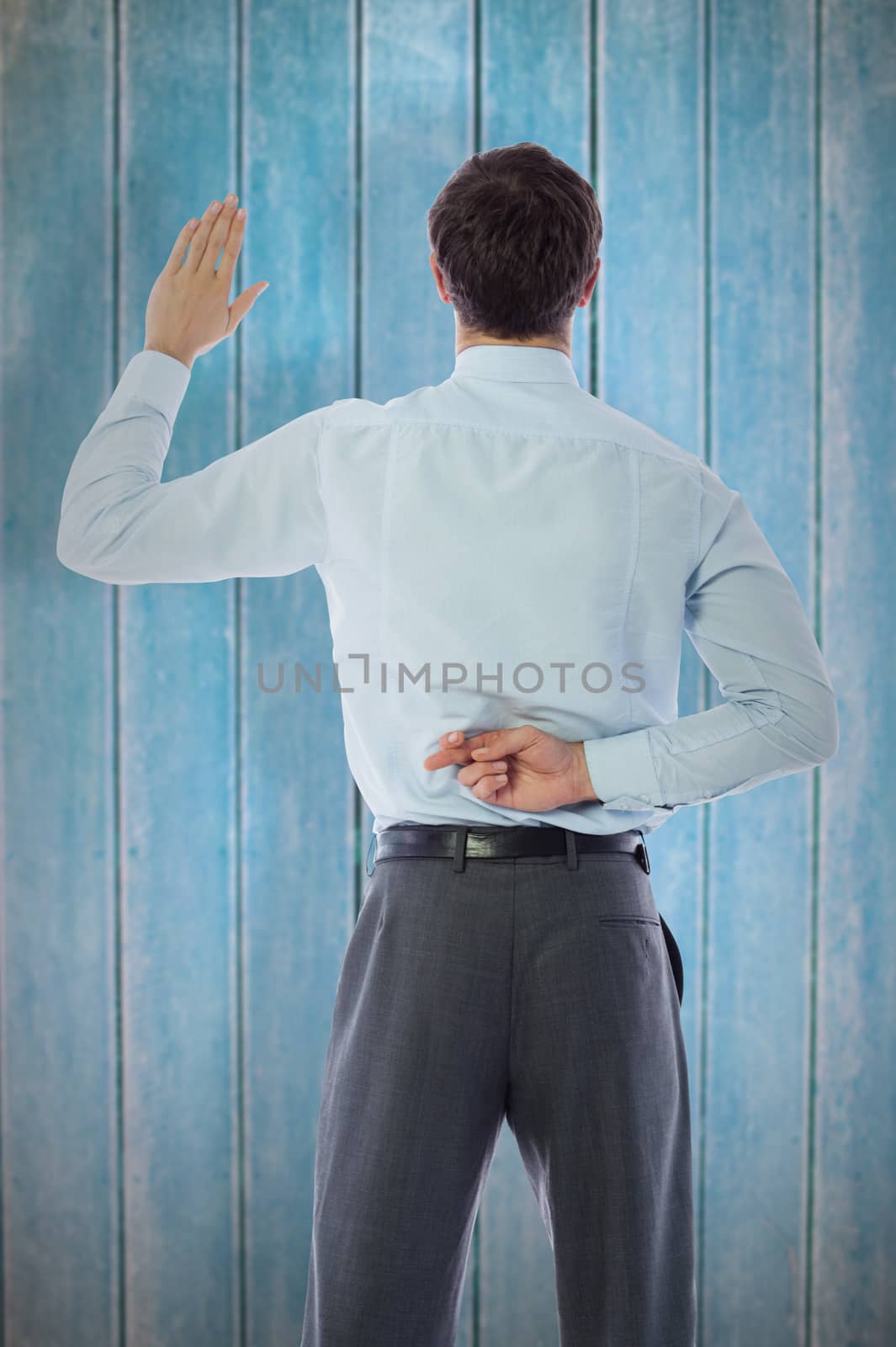 Composite image of businessman crossing fingers behind his back by Wavebreakmedia