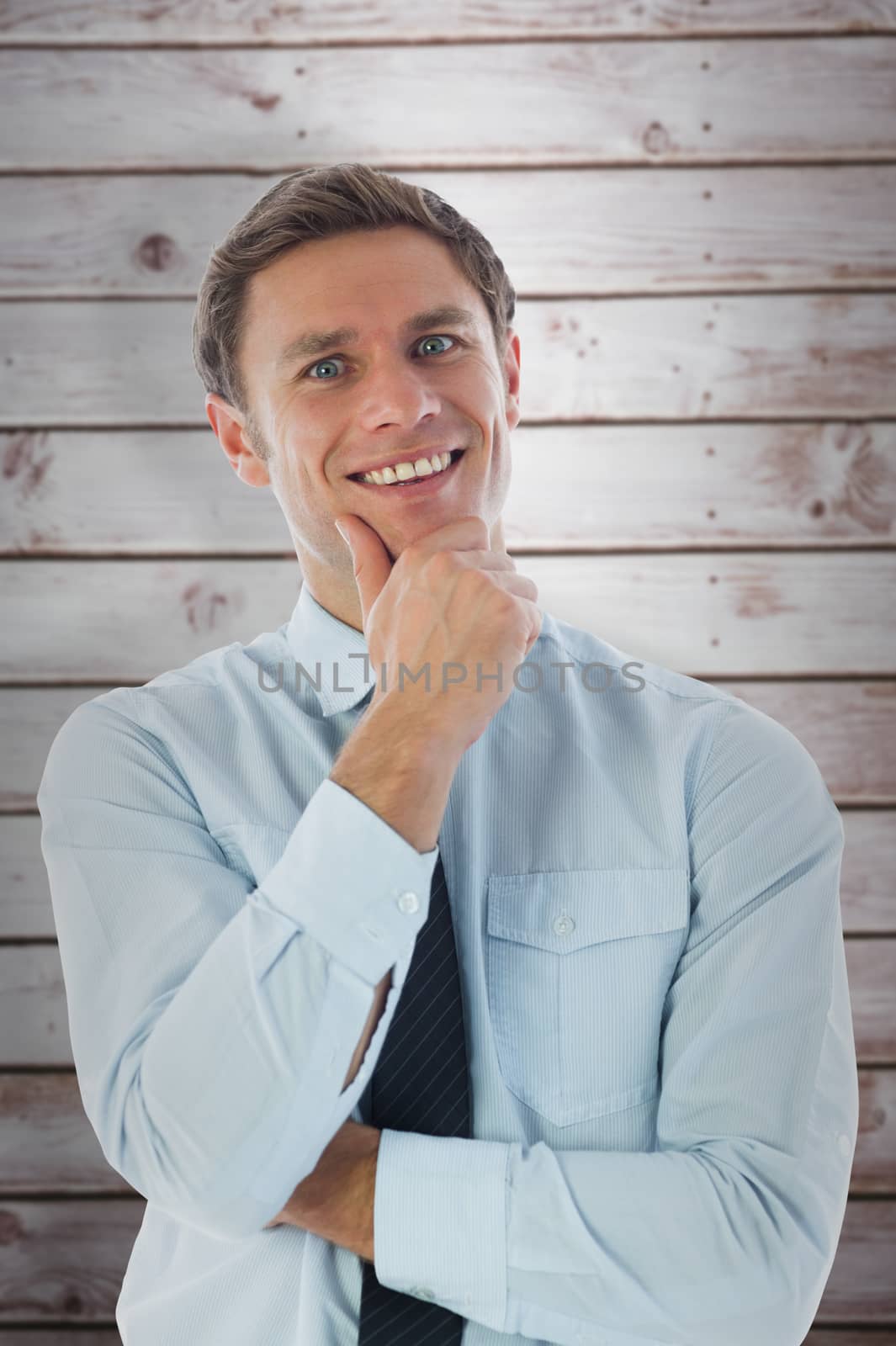 Thinking businessman with hand on chin against wooden planks