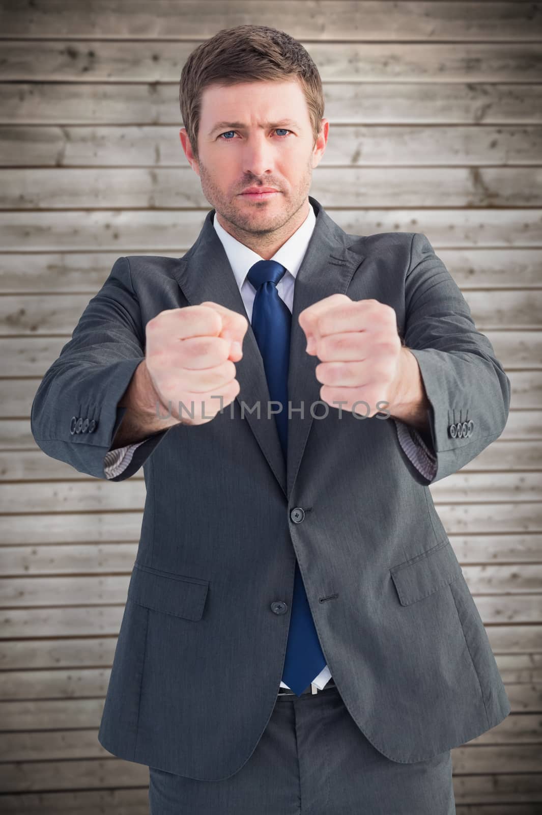 Composite image of businessman holding his hands out by Wavebreakmedia