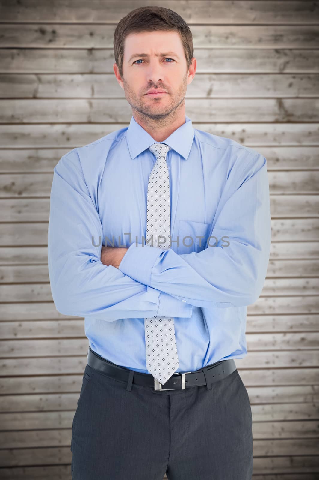 Businessman looking at the camera against wooden planks background