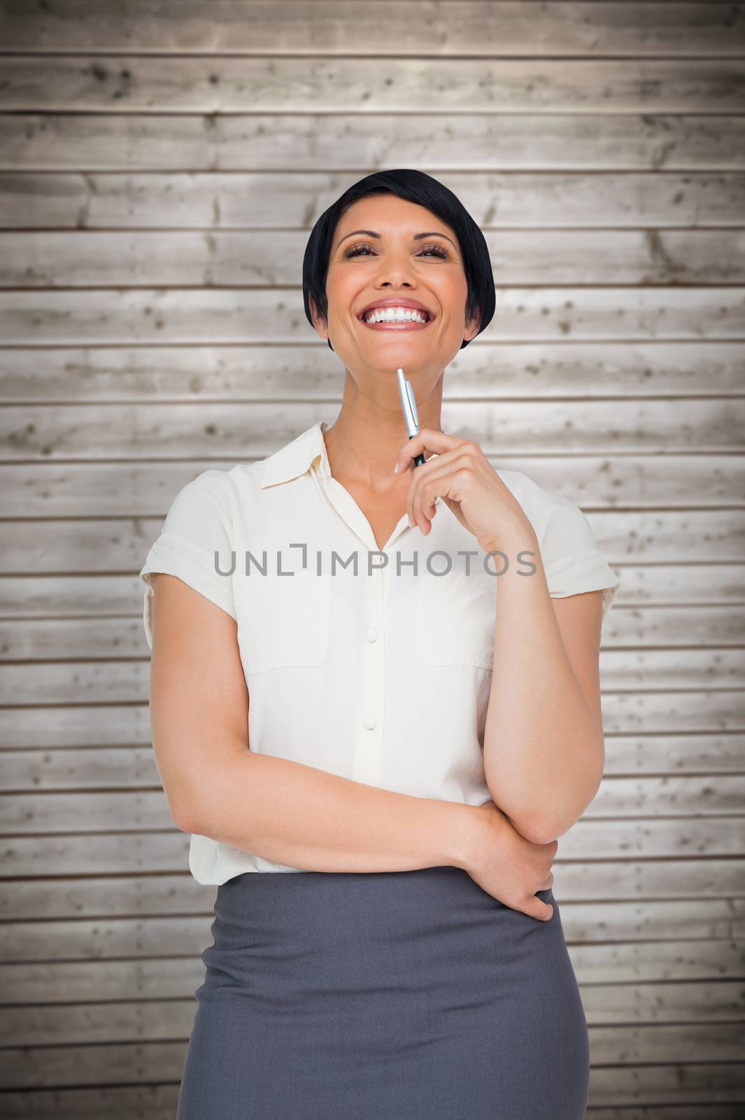 Thoughtful businesswoman against wooden planks background