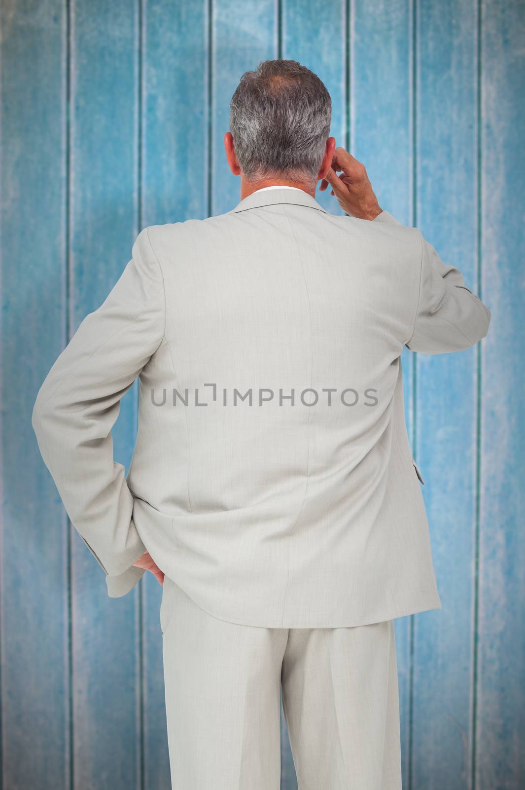 Thinking businessman against wooden planks