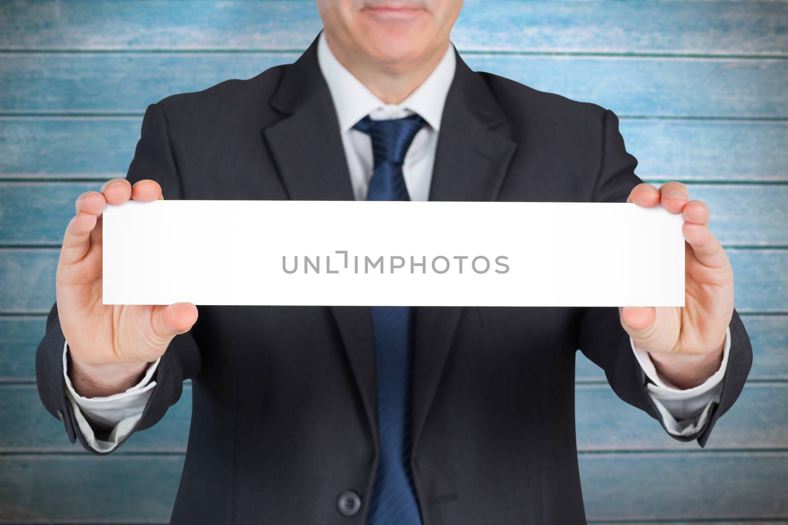 Composite image of mature businessman showing card by Wavebreakmedia