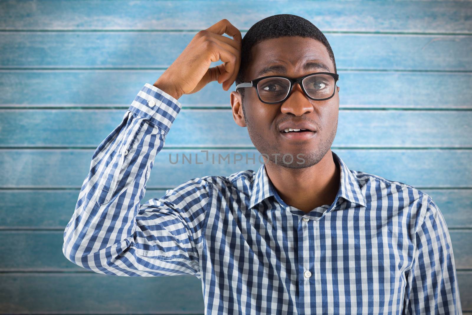 Composite image of young businessman thinking scratching head by Wavebreakmedia