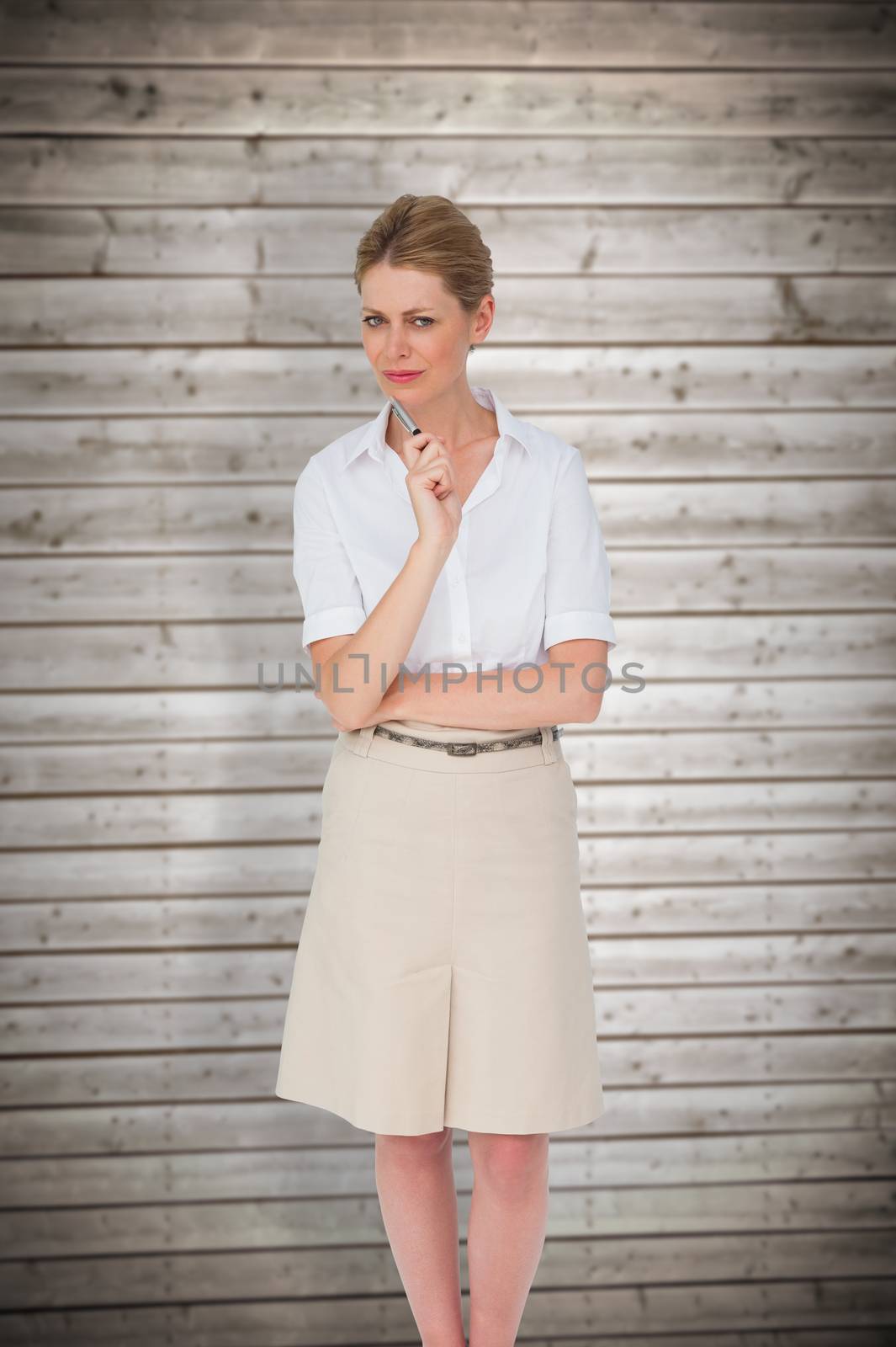 Thinking businesswoman against wooden planks background